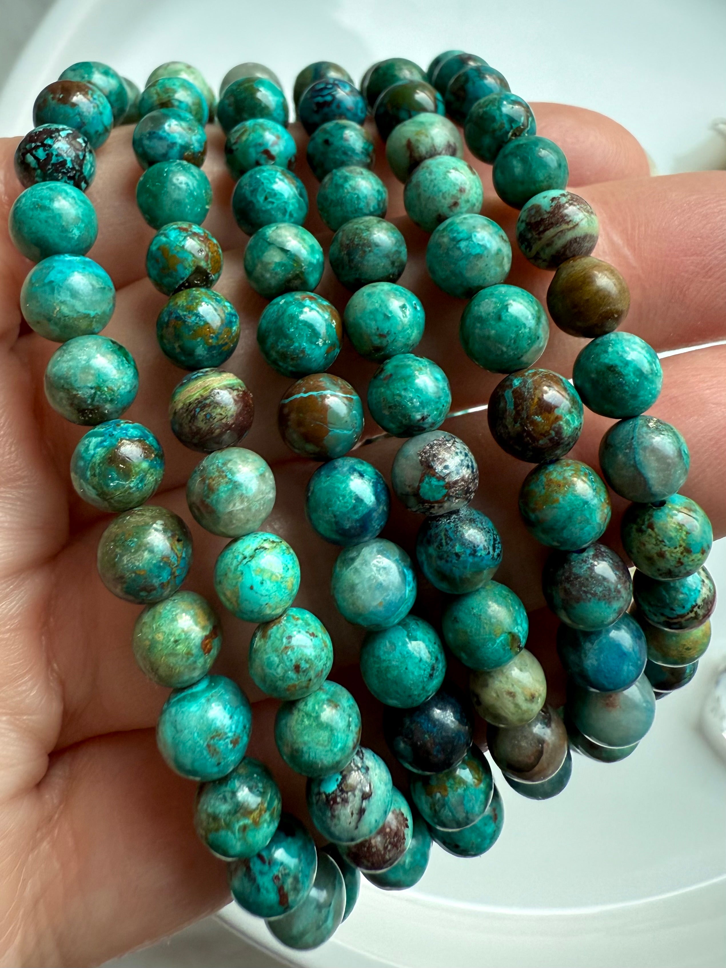 Chrysocolla Shattuckite beaded bracelets wrapped around wrist, turquoise-toned crystal jewelry for throat chakra healing