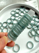 Stack of rounded Blue Water jade rings showing smooth polished jadeite bands