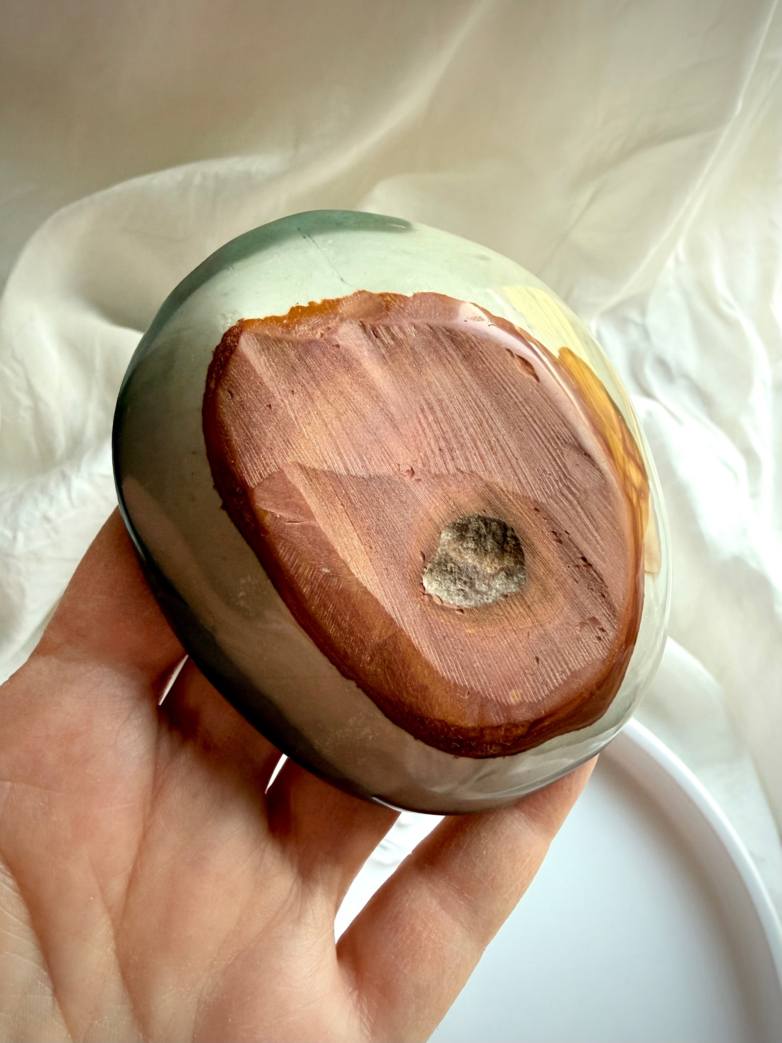 polychrome jasper bowl underside showing natural stone base and carving details
