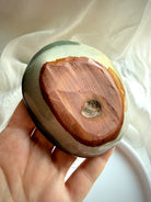 polychrome jasper bowl underside showing natural stone base and carving details