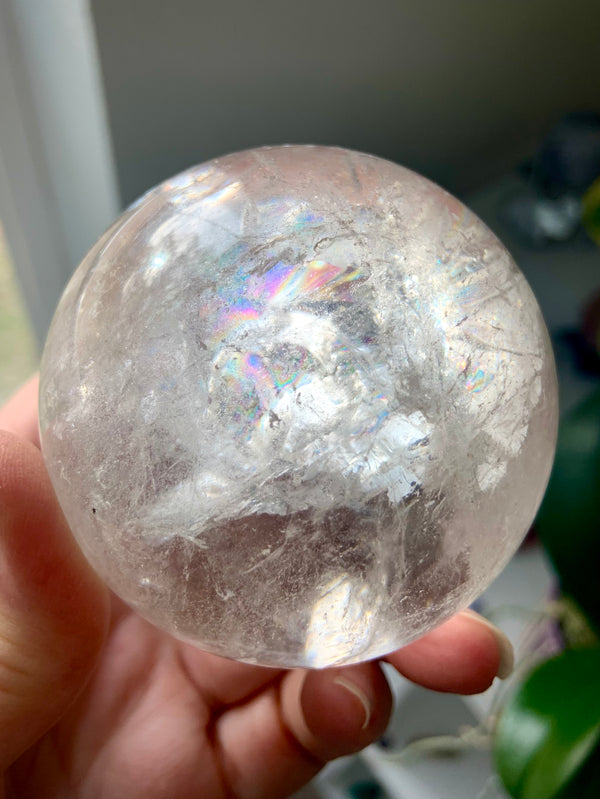 High quality Clear Quartz Crystal Sphere Filled with Rainbows makes an excellent gift for any crystal lover