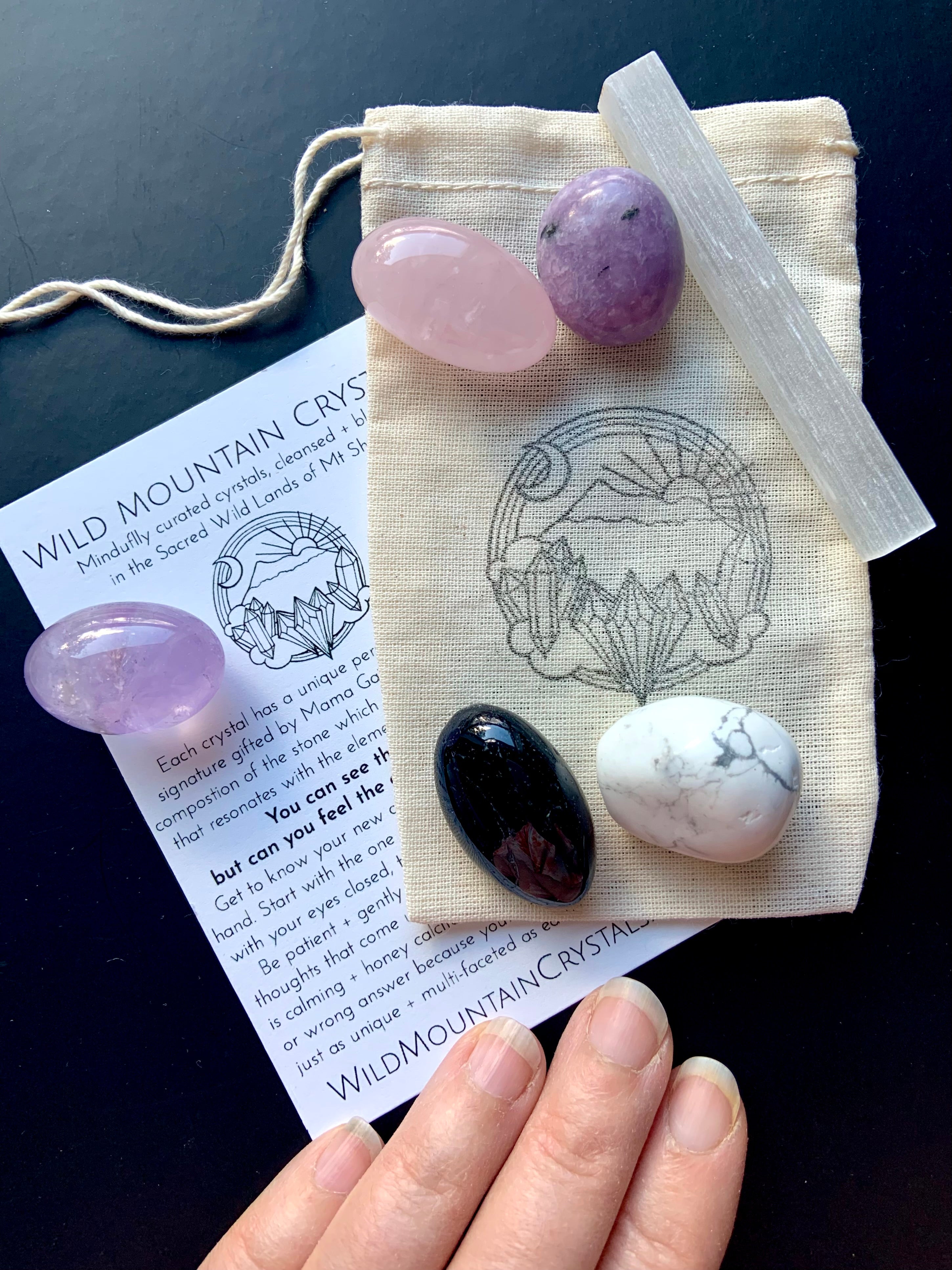 Sweet Sleep Crystal Set of 6 healing stones shown on a cotton pouch with Wild Mountain Crystal logo