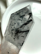 black tourmaline in quartz point tip showing needle inclusions