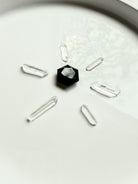 Obsidian hexagon placed in sacred geometry layout