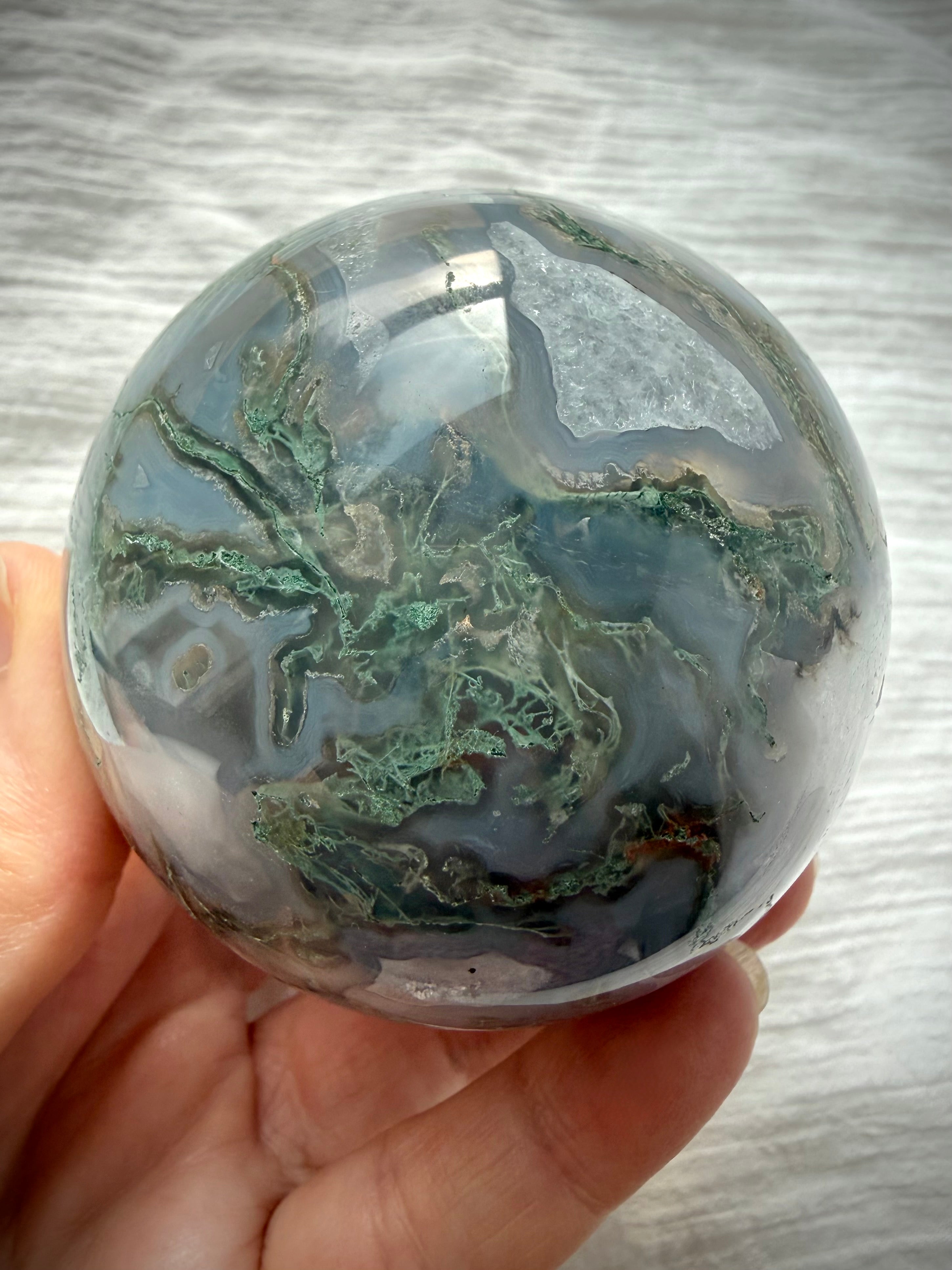 Moss Agate sphere with intricate green dendritic patterns, translucent gray chalcedony and natural Quartz crystal formations