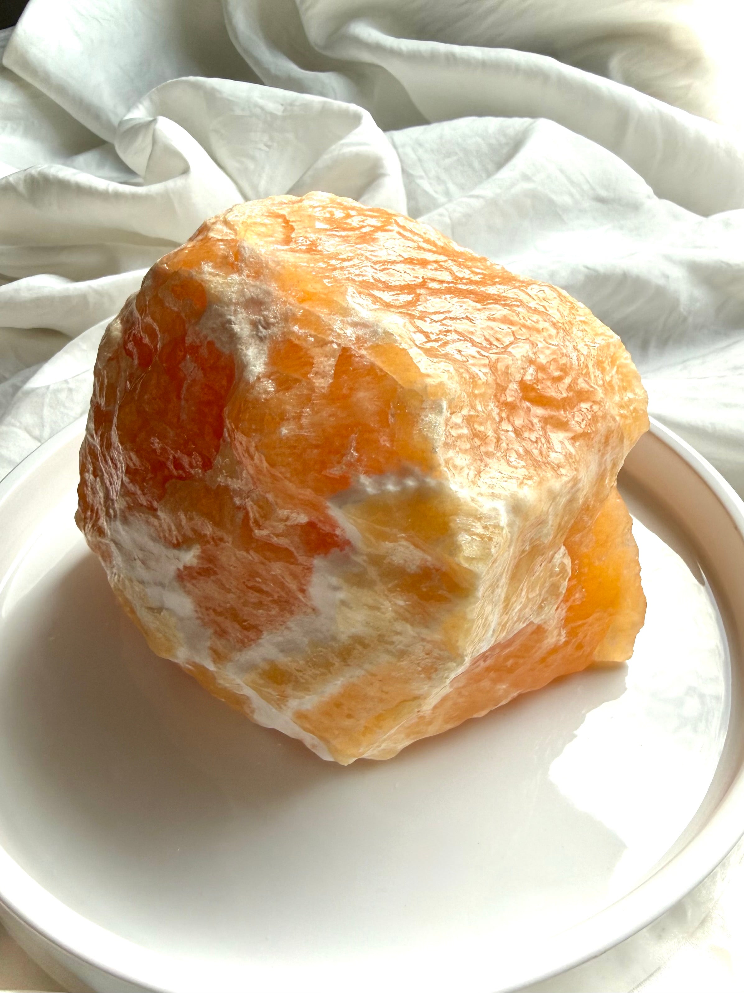 Large Orange Calcite statement crystal with natural texture, translucent edges, and self-standing form