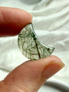 Mini Green Tourmaline Quartz moon held in hand showing translucent crystal and natural green tourmaline inclusions
