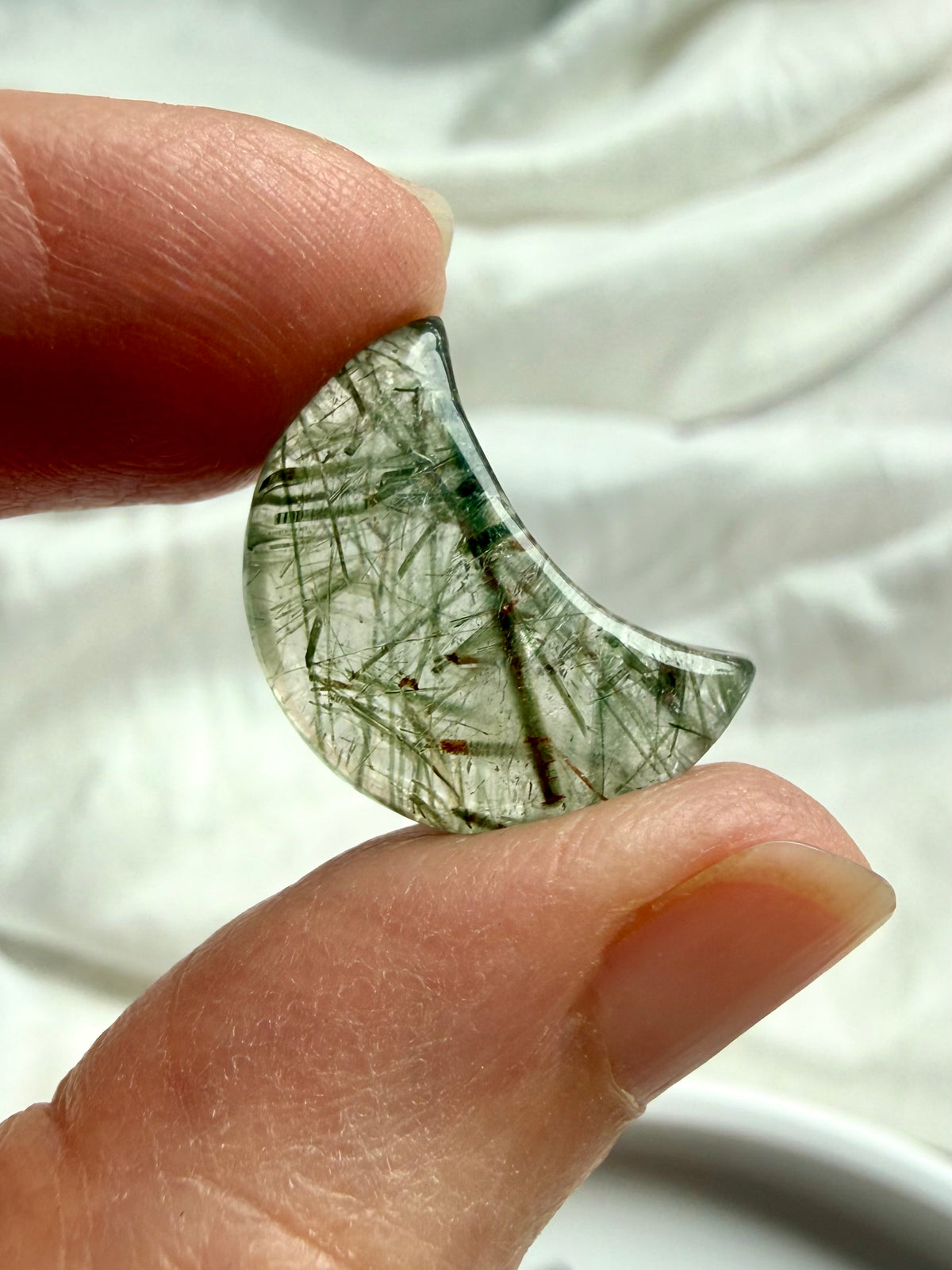 Mini Green Tourmaline Quartz moon held in hand showing translucent crystal and natural green tourmaline inclusions