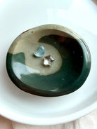 shallow polychrome jasper crystal bowl with flowing teal wave pattern and earthy tones 