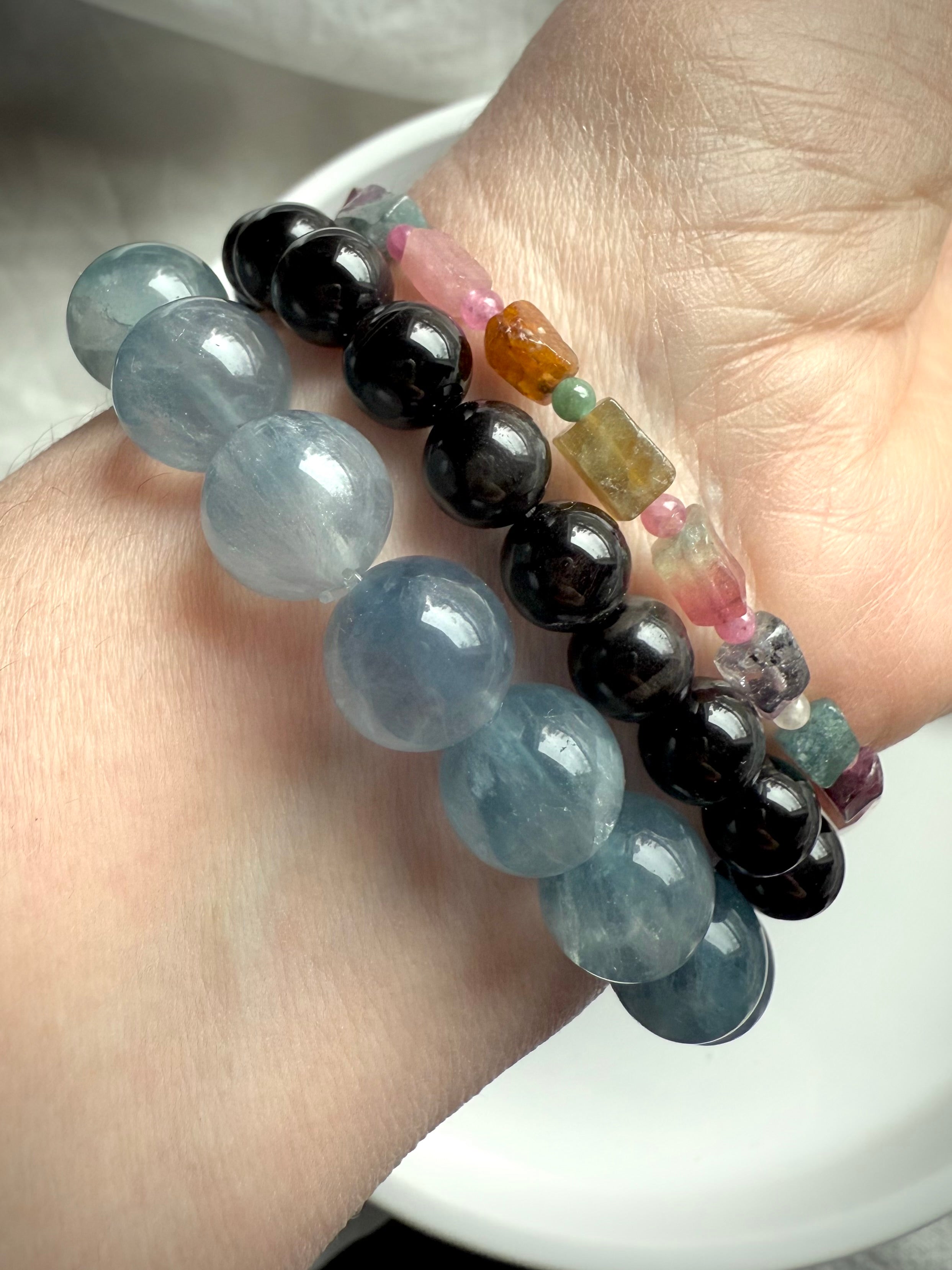 Our Black Tigers Eye Bracelet worn with Ice Blue Fluorite + Watermelon Tourmaline Bracelets