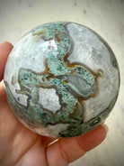 Large Moss Agate crystal ball with white Quartz formations and scenic forest-like mineral inclusions