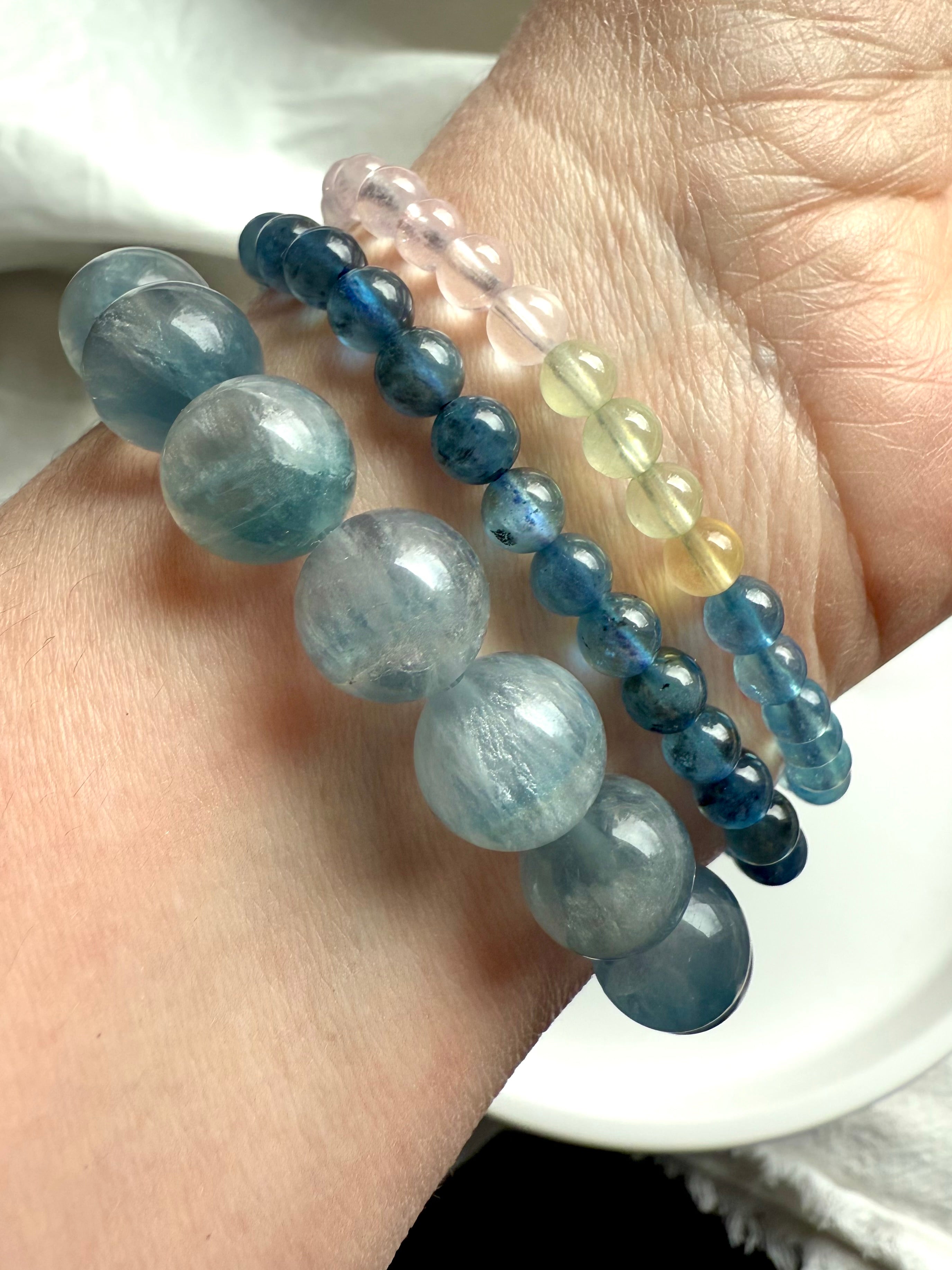 High quality morganite bracelets worn with an aquamarine bracelet + a silky blue fluorite bracelet