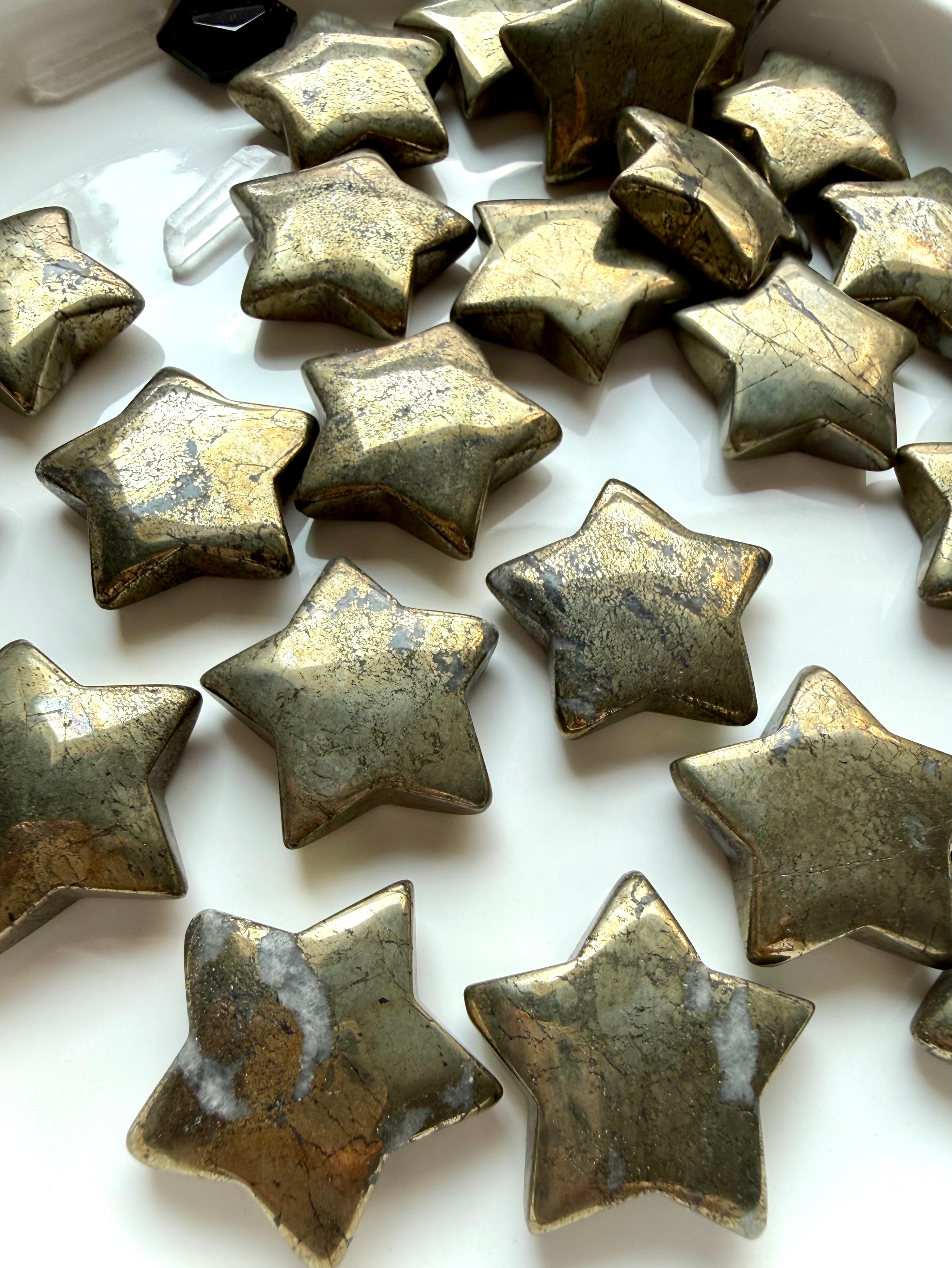 Golden Pyrite star carvings arranged together showing natural metallic luster and unique surface patterns