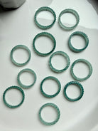 Natural Guatemalan Blue Water Jade woven rings arranged in circle, premium jadeite bands with luminous teal glow