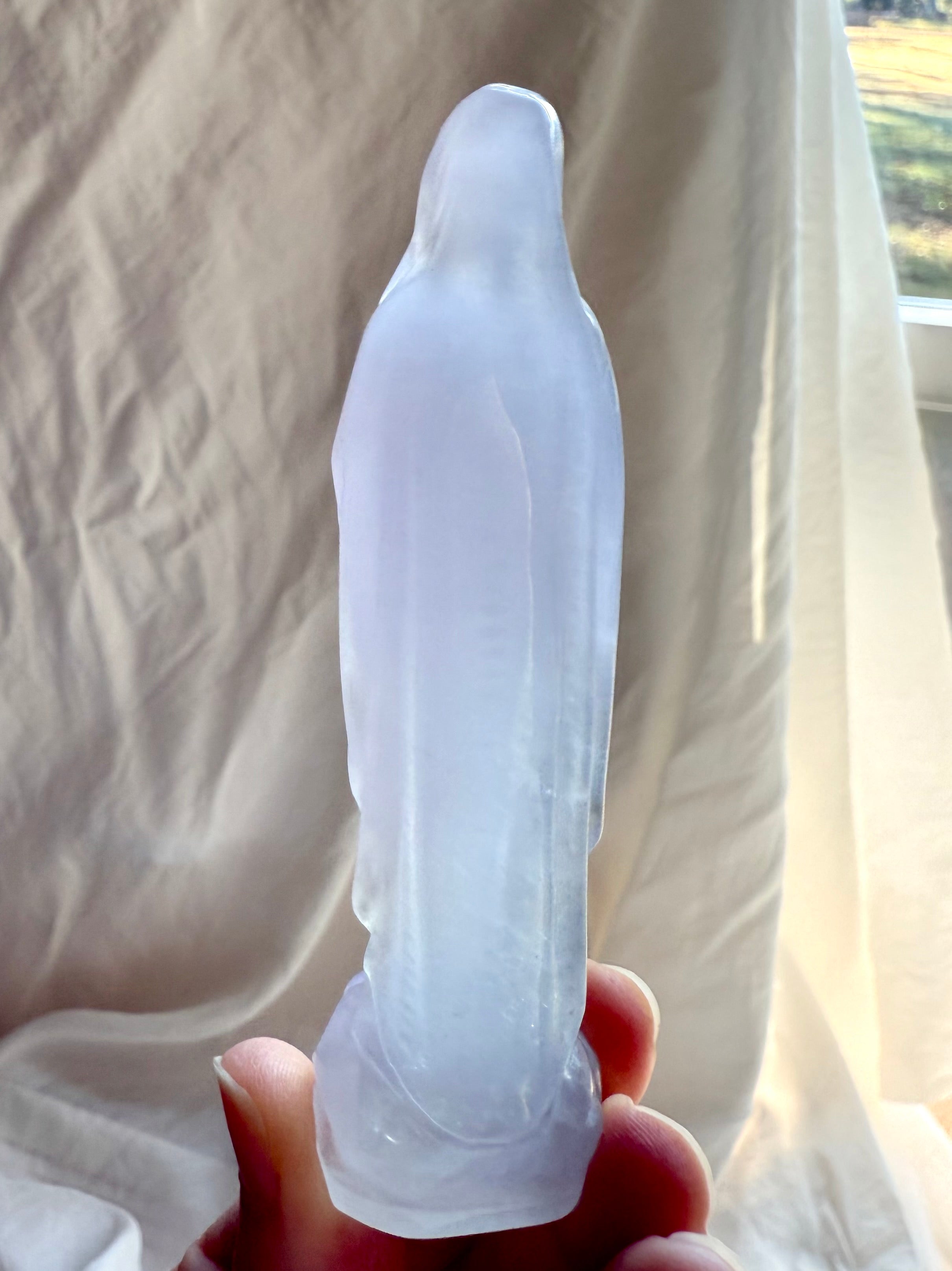 Back view of Lavender Fluorite Mother Mary statue showing flowing carved robes and luminous translucent crystal