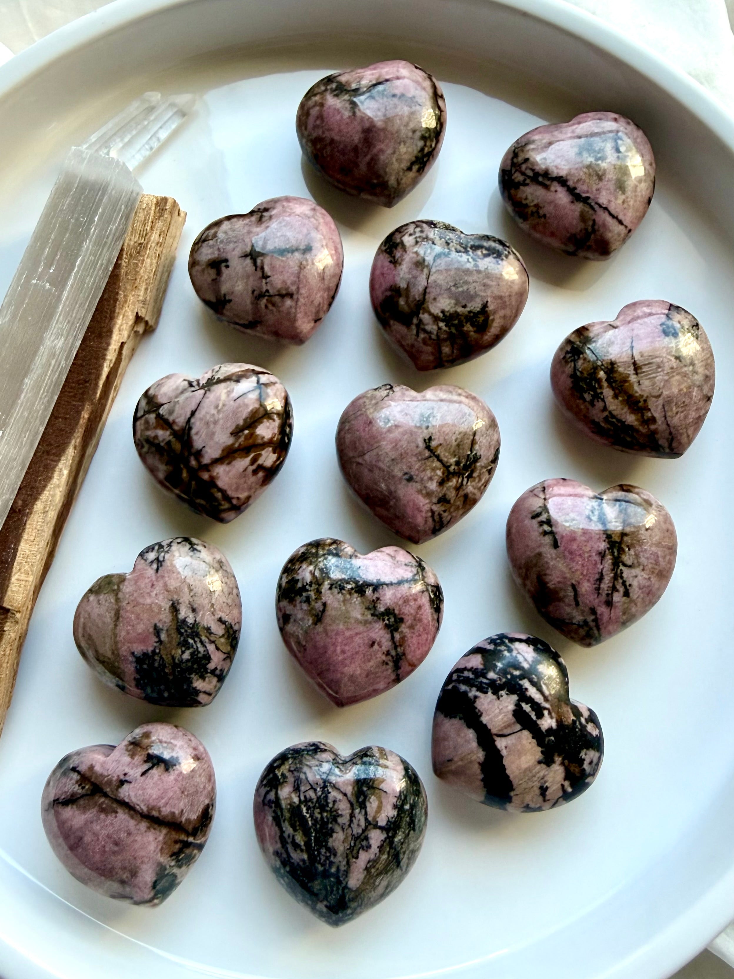 Rhodonite heart carvings with natural pink and black manganese patterns for emotional healing, self-love and compassion