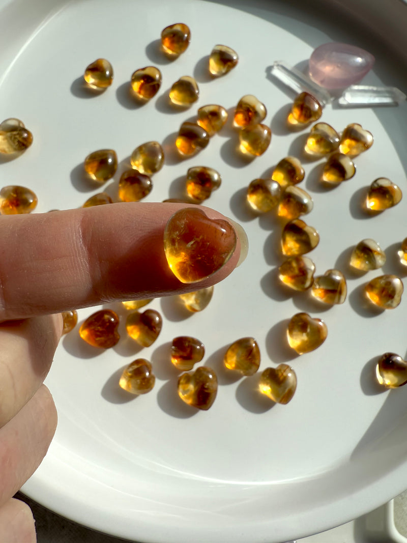 A Mini Citrine Heart shown on my fingertip for scale