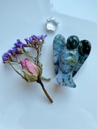 Hand-carved Moss Agate angel figurine with Clear Quartz star and dried flower bouquet.