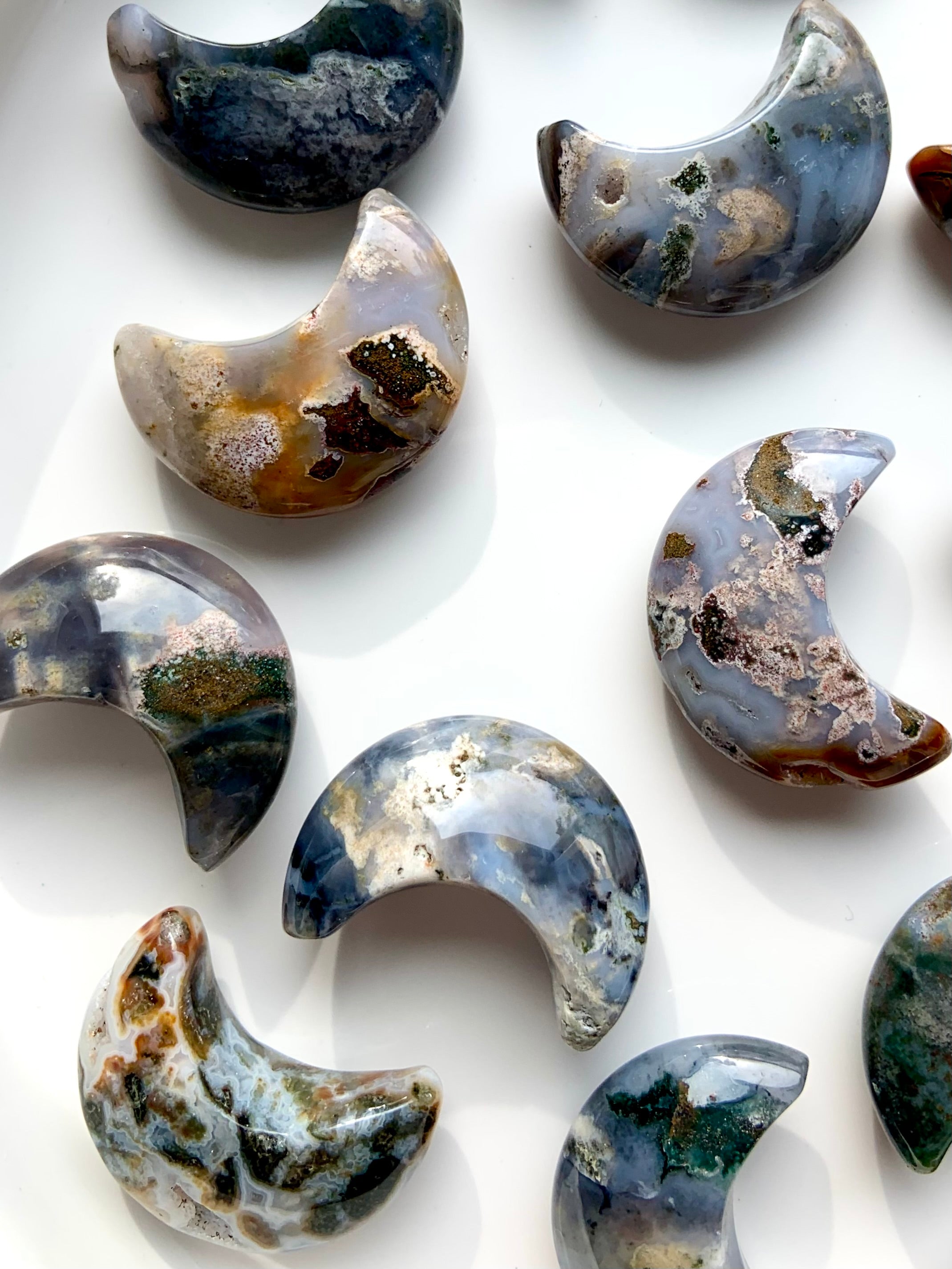 Macro closeup of Cosmic Ocean Jasper moon carvings with natural patterns