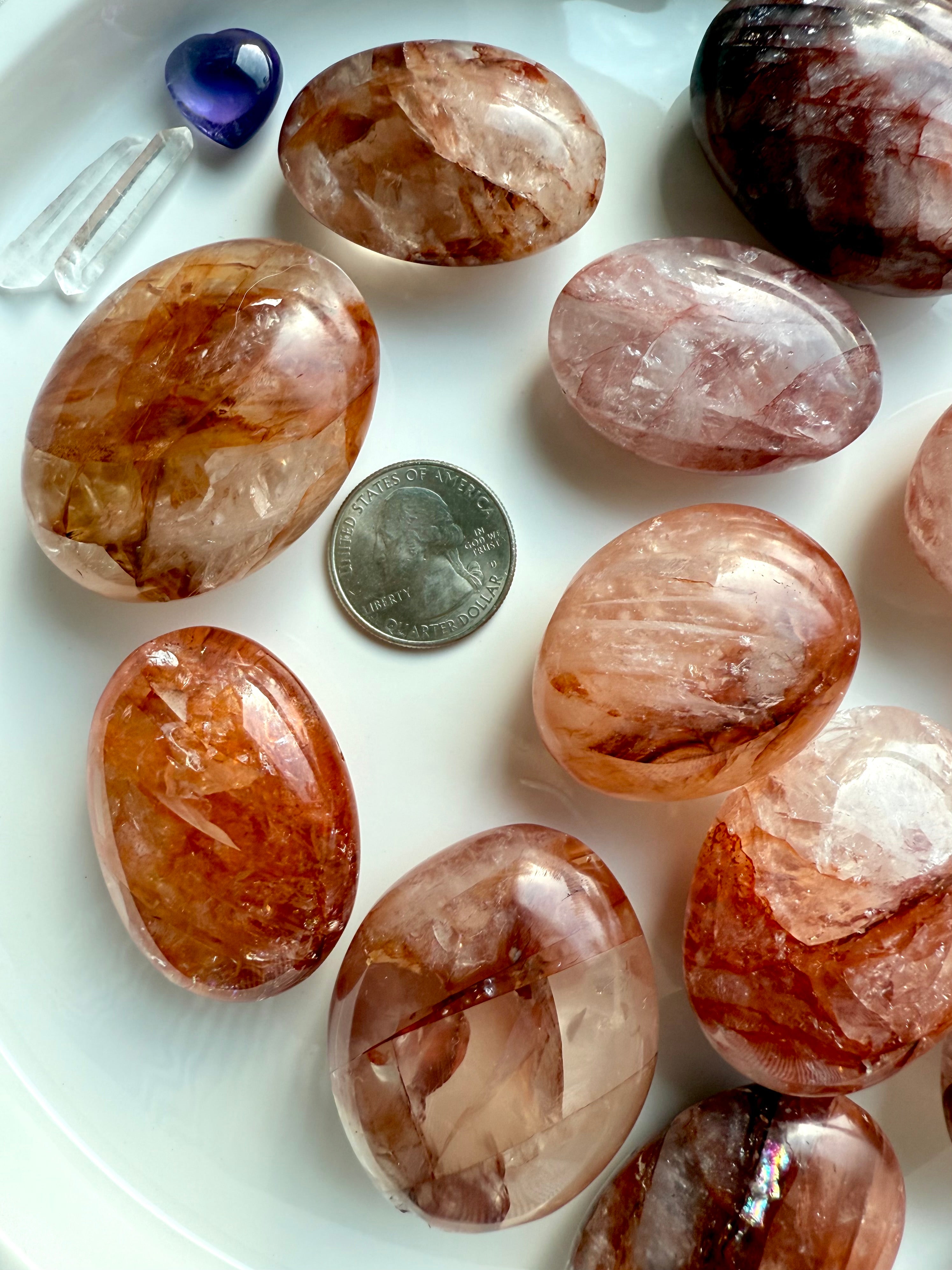 Fire Quartz palm stones with quarter for size reference, styled with crystals for healing energy work