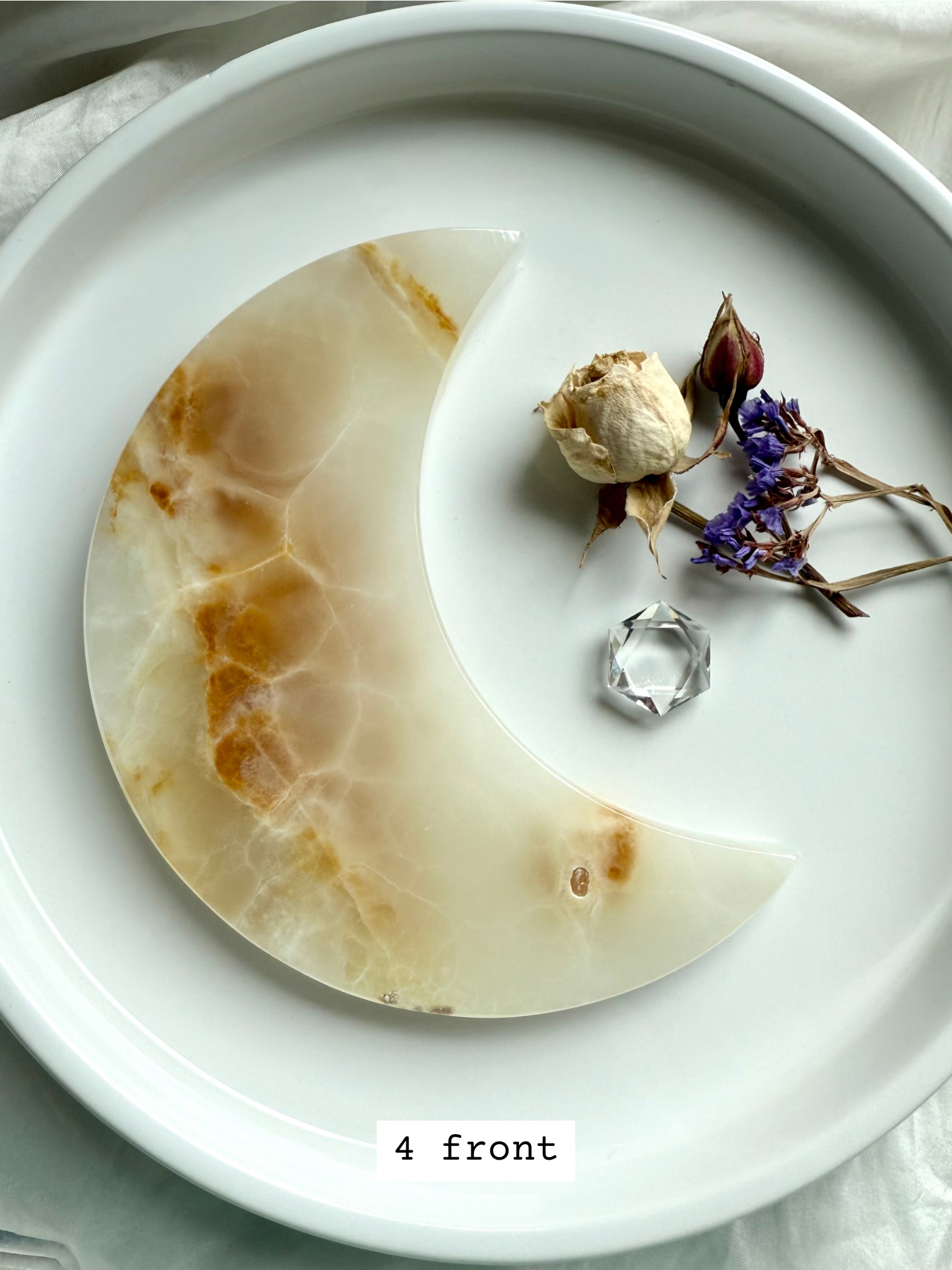 White Onyx Crescent Moon Plate, translucent white with golden tones and banding, front view.