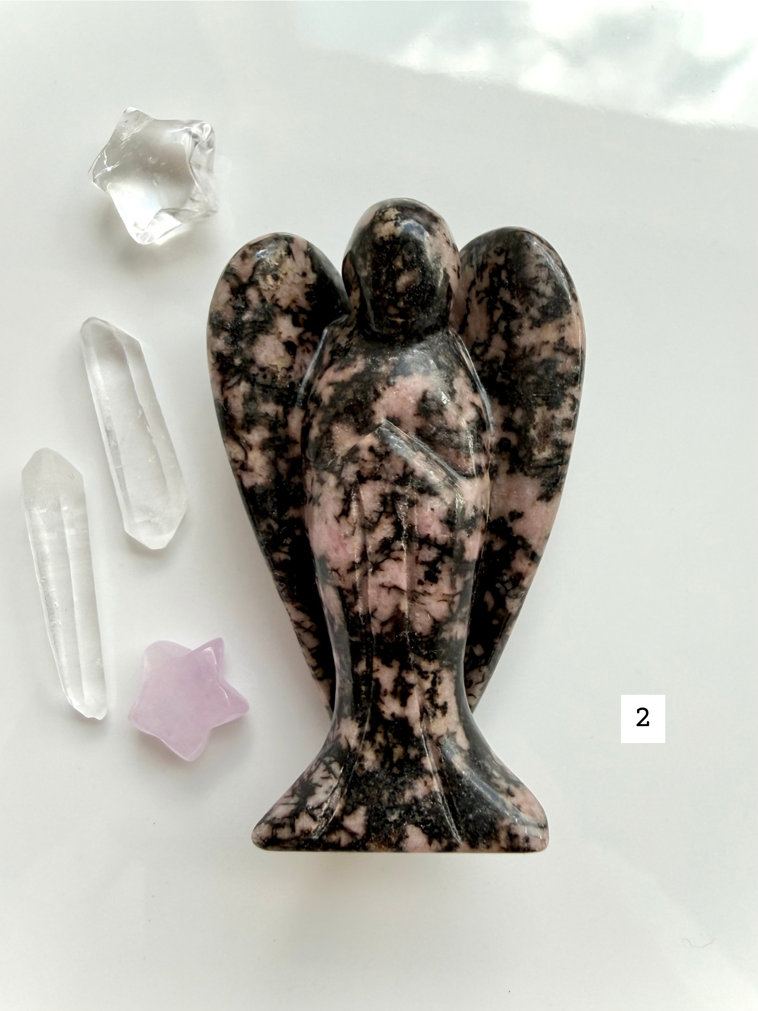 Pink Rhodonite crystal guardian with dark matrix and soothing heart chakra energy