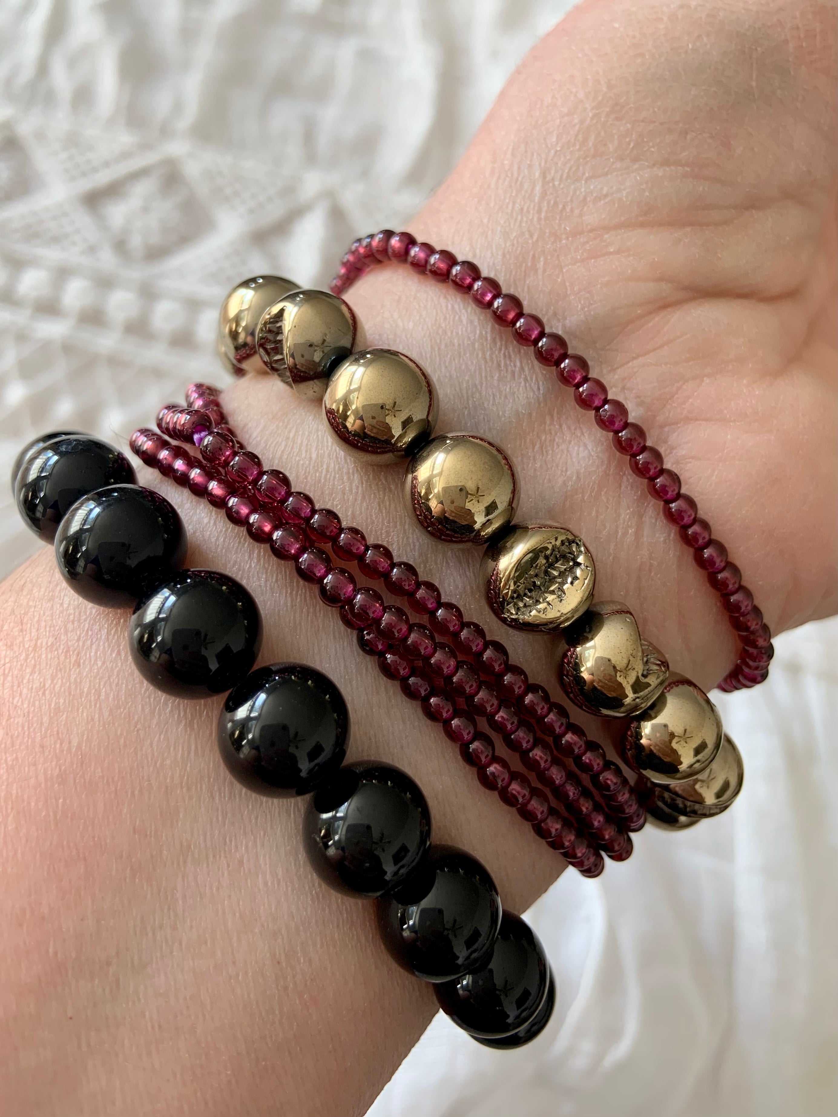 Black Tourmaline bracelet worn with Pyrite and Garnet bracelets — powerful crystal stack for protection, grounding & abundance
