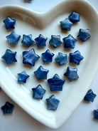 Polished Blue Kyanite crystal stars in a white heart dish with natural blue shimmer and unique patterning