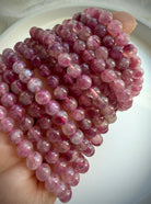 Pink Tourmaline bracelet layered on wrist, showcasing romantic pink gemstone jewelry for October birthstone gifts