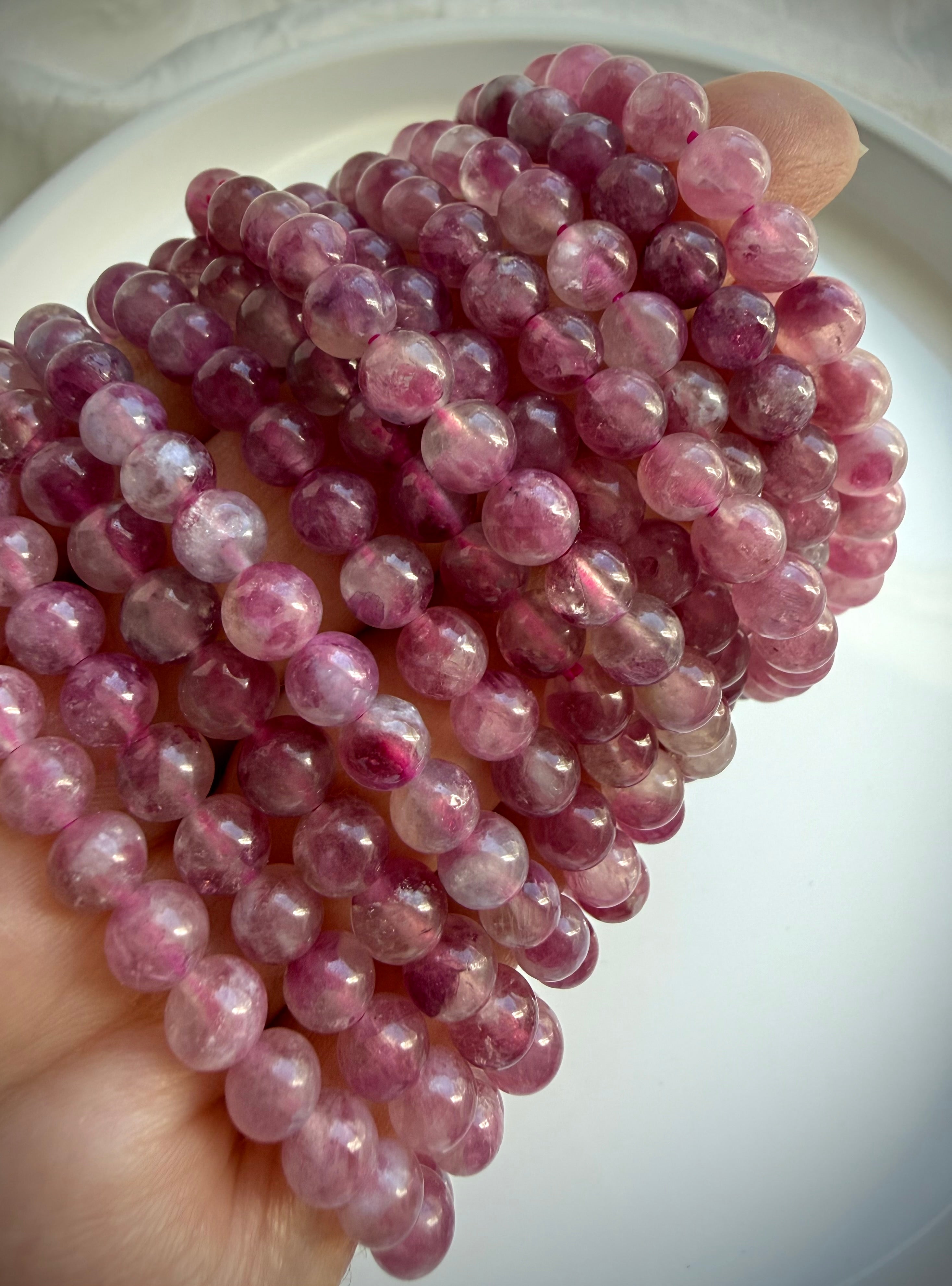 Pink Tourmaline bracelet layered on wrist, showcasing romantic pink gemstone jewelry for October birthstone gifts