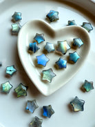 Overhead view of pastel Labradorite stars in a ceramic heart bowl — high-vibe micro crystal stars for intuition, calm & sacred space styling.