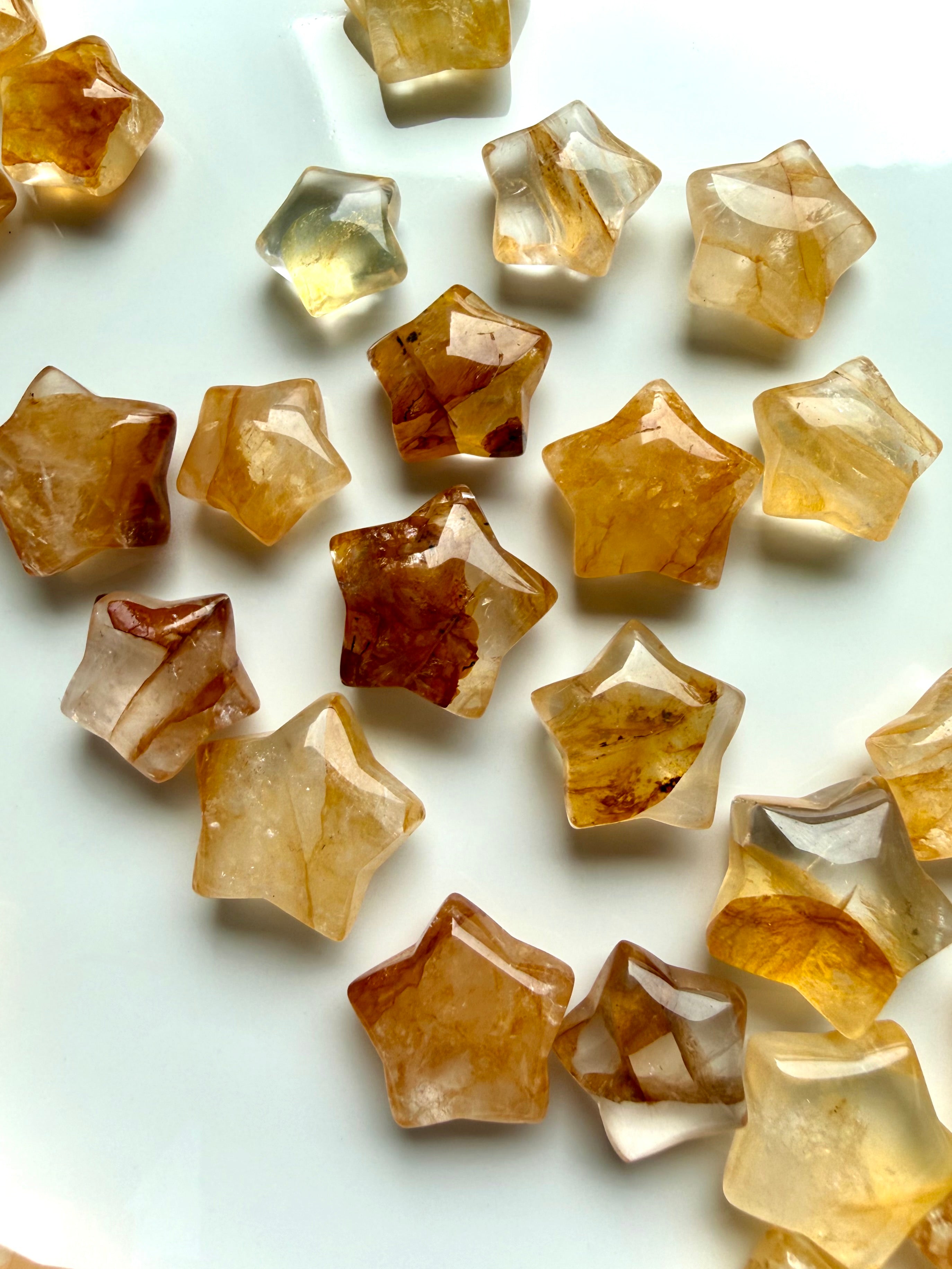 Close up of Golden Healer Quartz crystal stars with warm golden tones for healing energy, confidence, and manifestation
