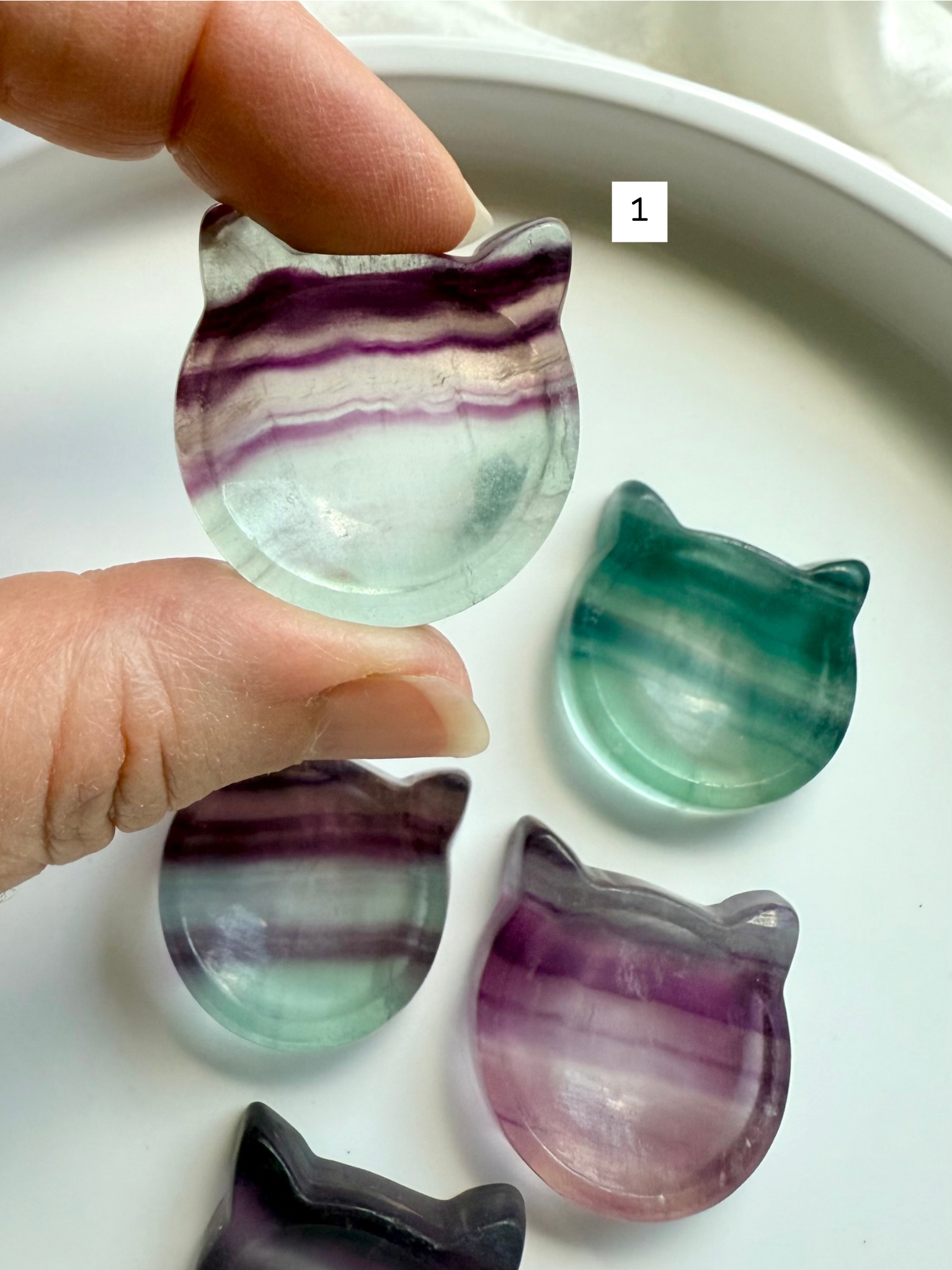 Fluorite cat-shaped crystal bowl held to the light – mini ring dish and jewelry holder