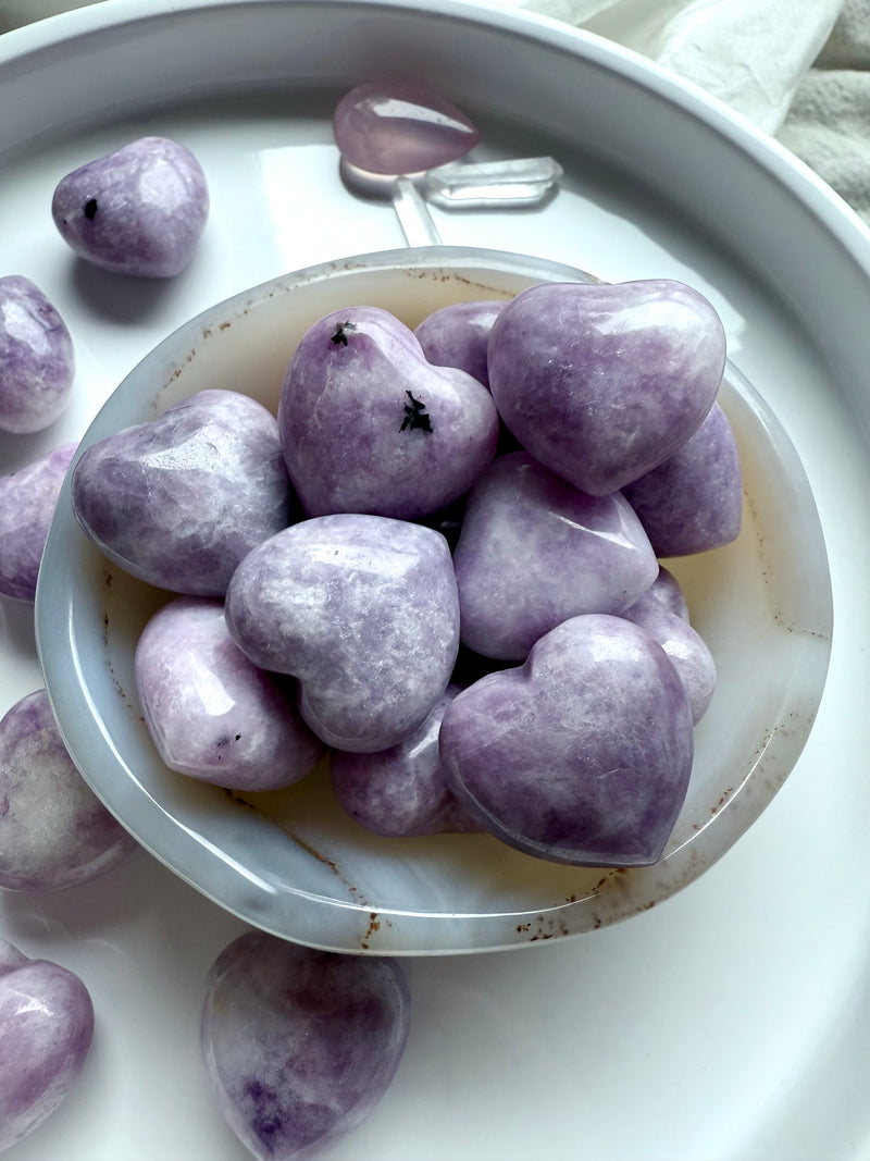 Purple Lepidolite heart carvings make a soothing pocket stone for stress relief + emotional support