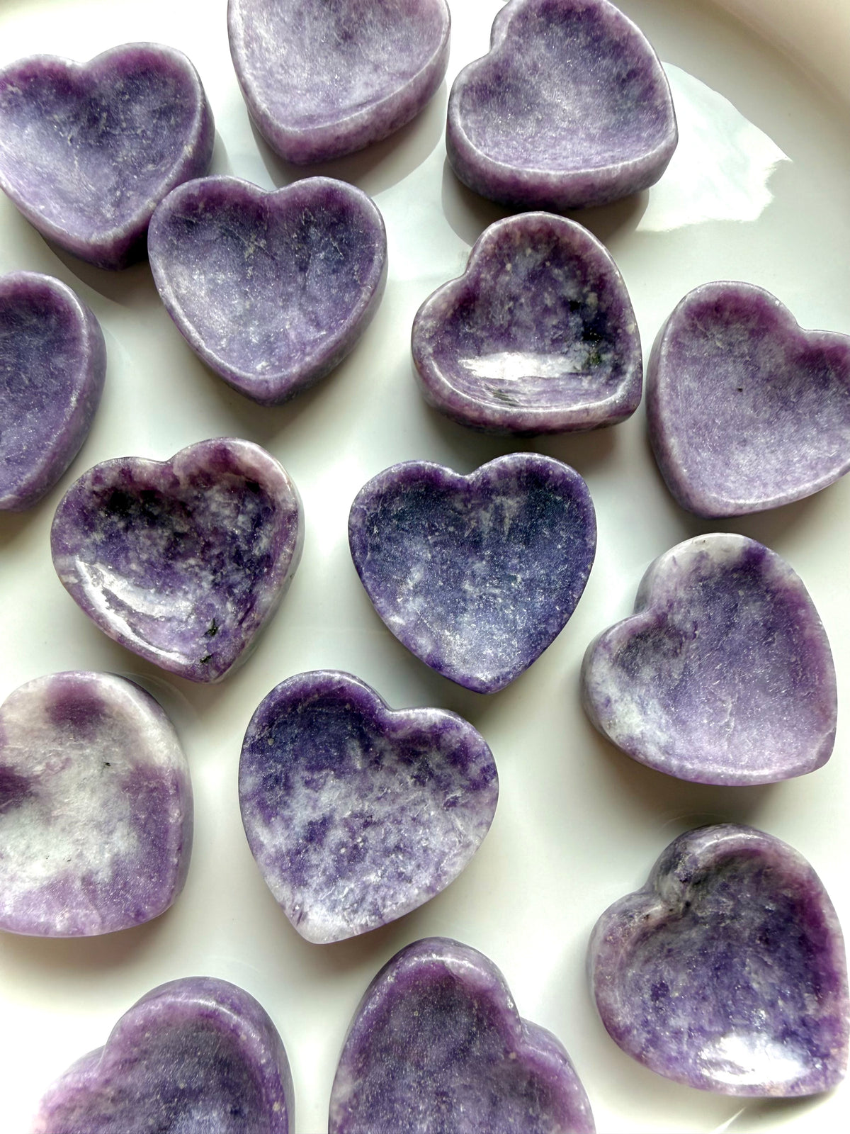 Purple Lepidolite heart bowls arranged together showing unique lavender tones, marbling and petite crystal dish shapes