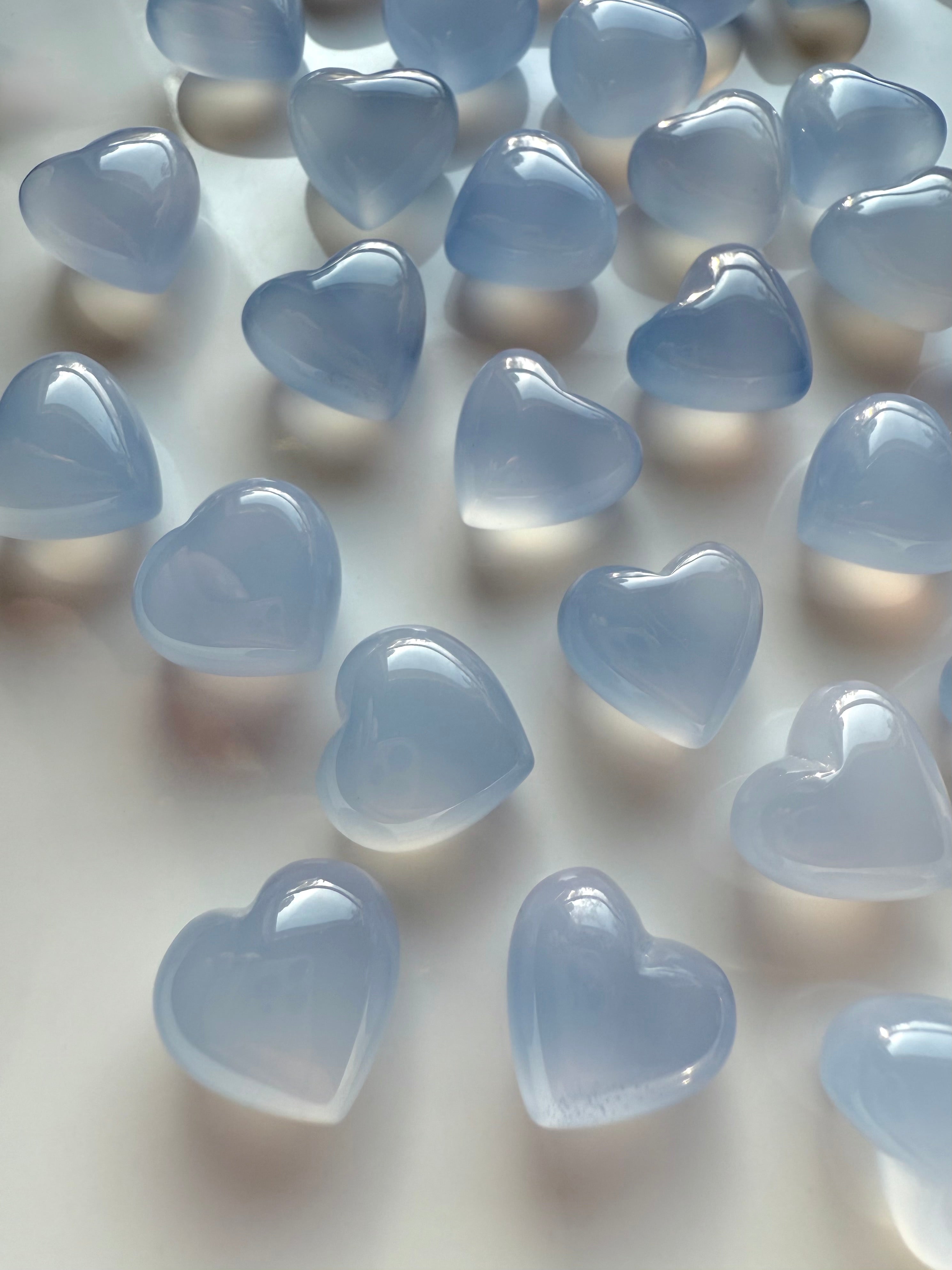 Polished Blue Chalcedony heart crystals in pale blue tones, soothing healing stones for calm energy and mindful rituals