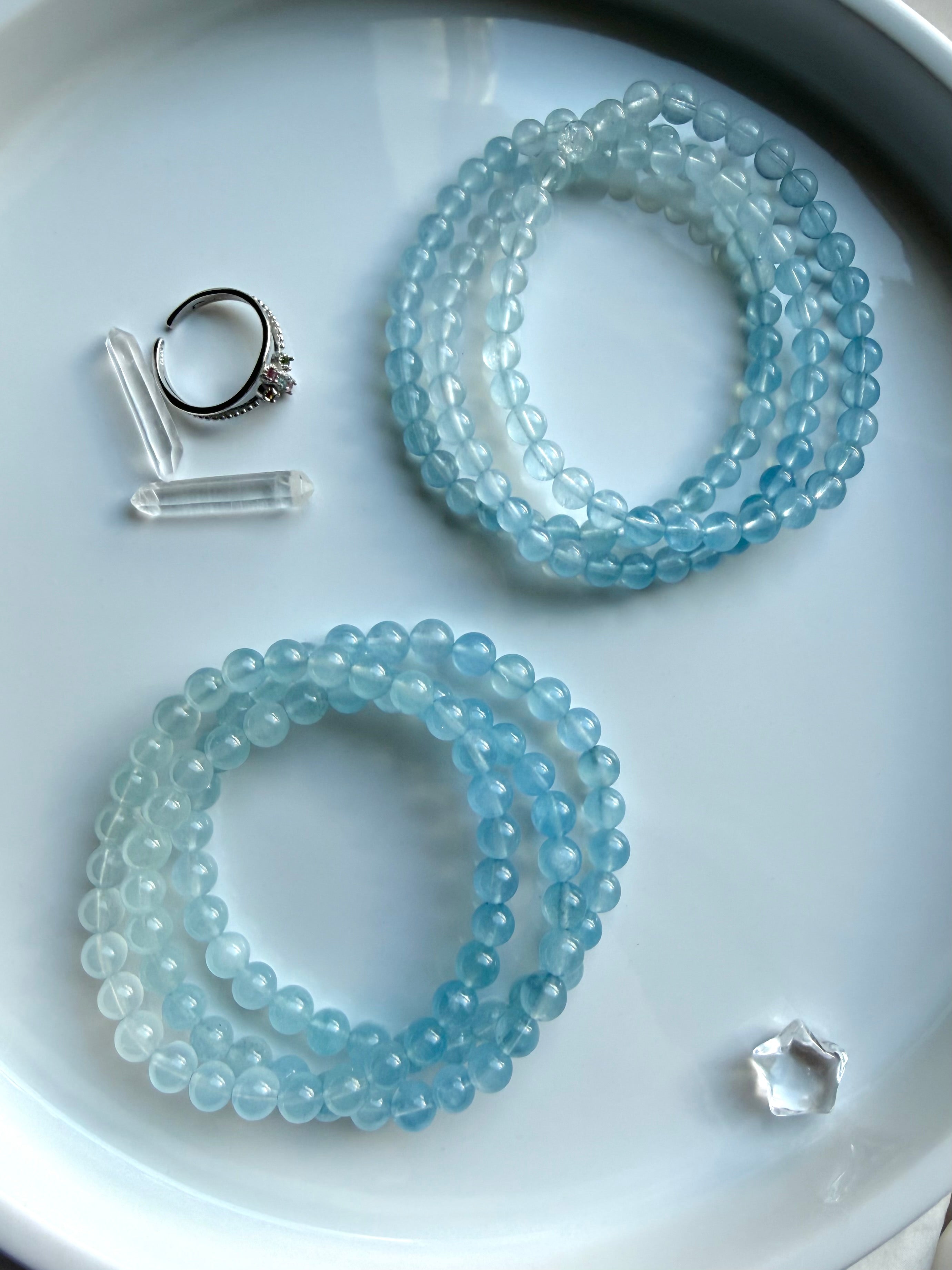 Aquamarine March birthstone bracelets shown in two stacks showing – blue ombré details