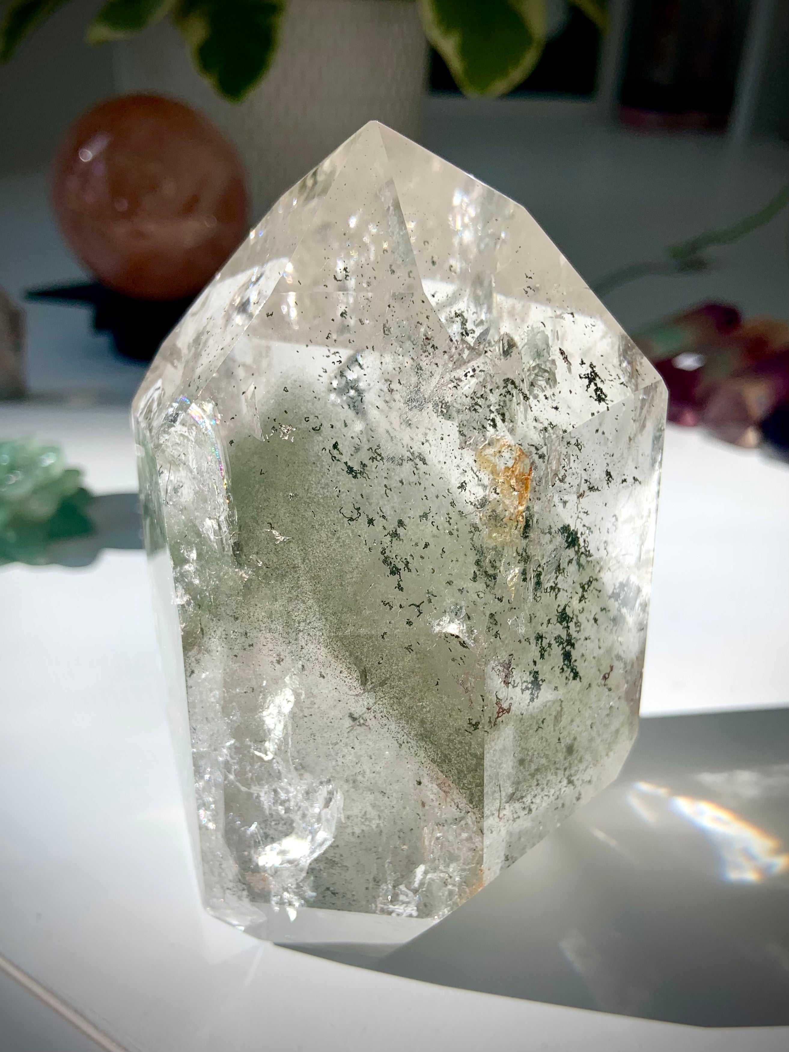 A self standing Garden Quartz Lodolite Crystal with phantoms, mossy mineral inclusions + rainbows