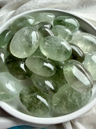 Prasiolite palm stones with luminous green color and polished palm stone shape