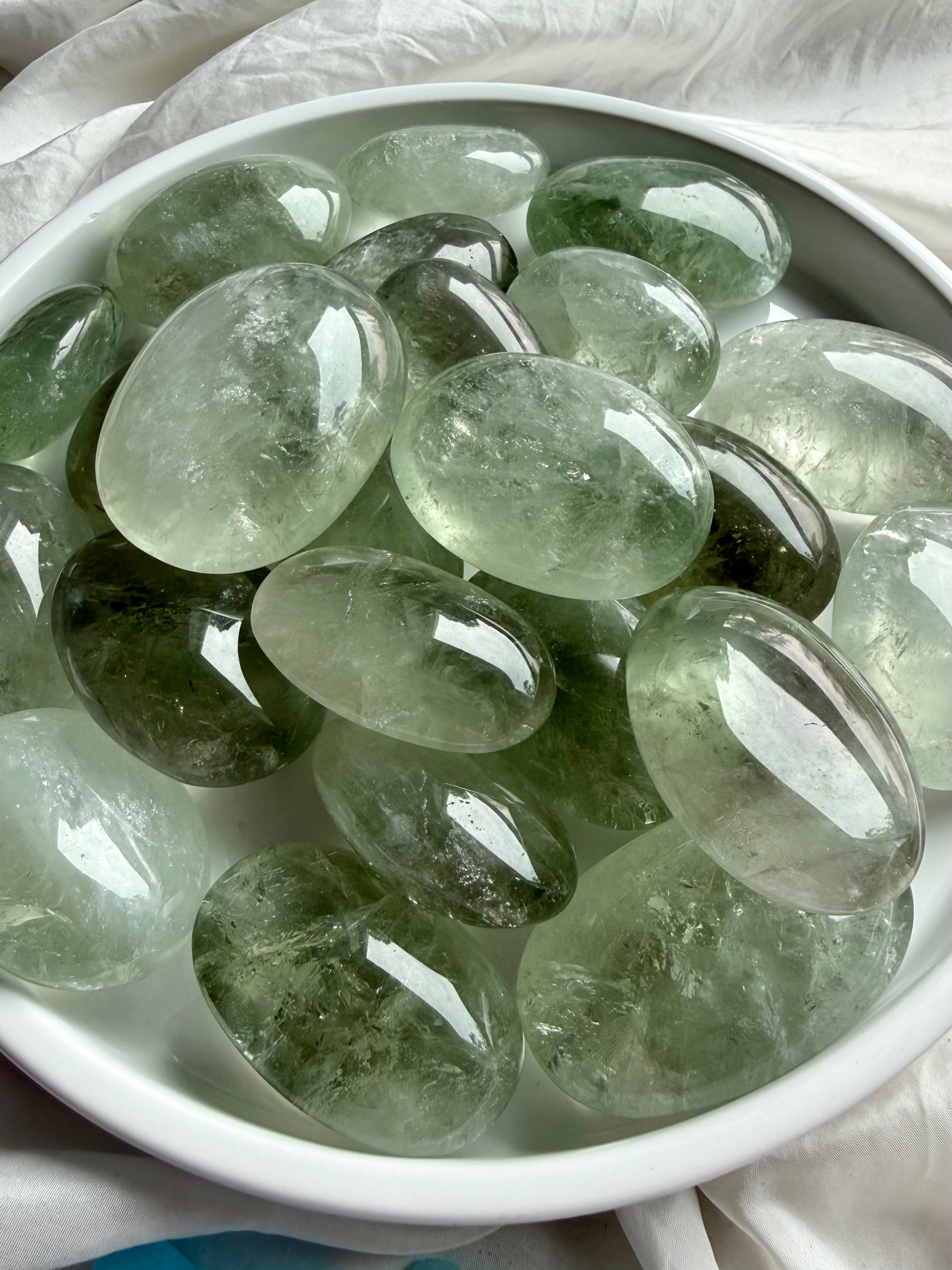 Prasiolite palm stones with luminous green color and polished palm stone shape