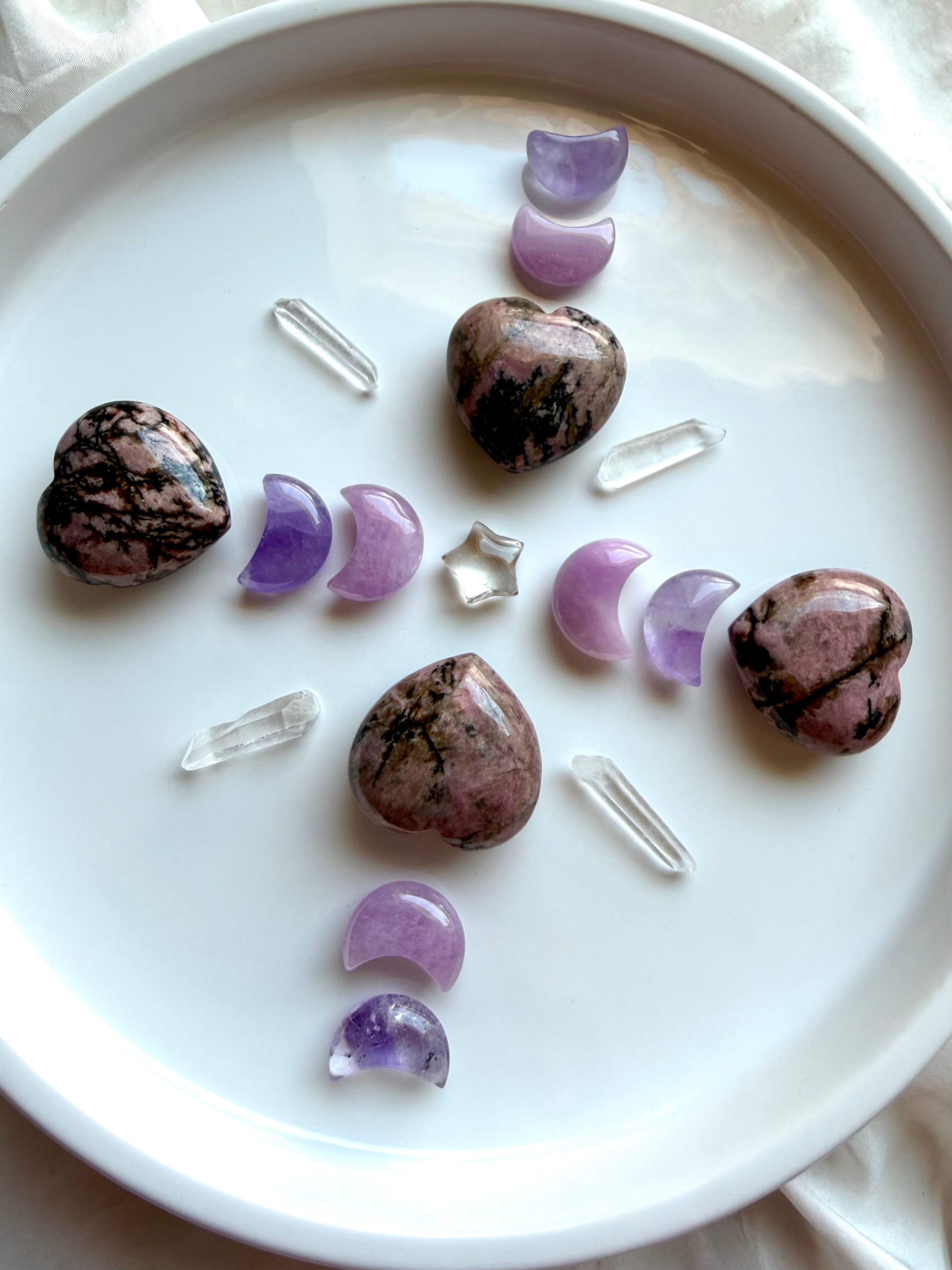 Rhodonite hearts with Amethyst and Kunzite moons, Clear Quartz points and crystal star in a crystal grid