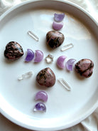 Rhodonite hearts with Amethyst and Kunzite moons, Clear Quartz points and crystal star in a crystal grid