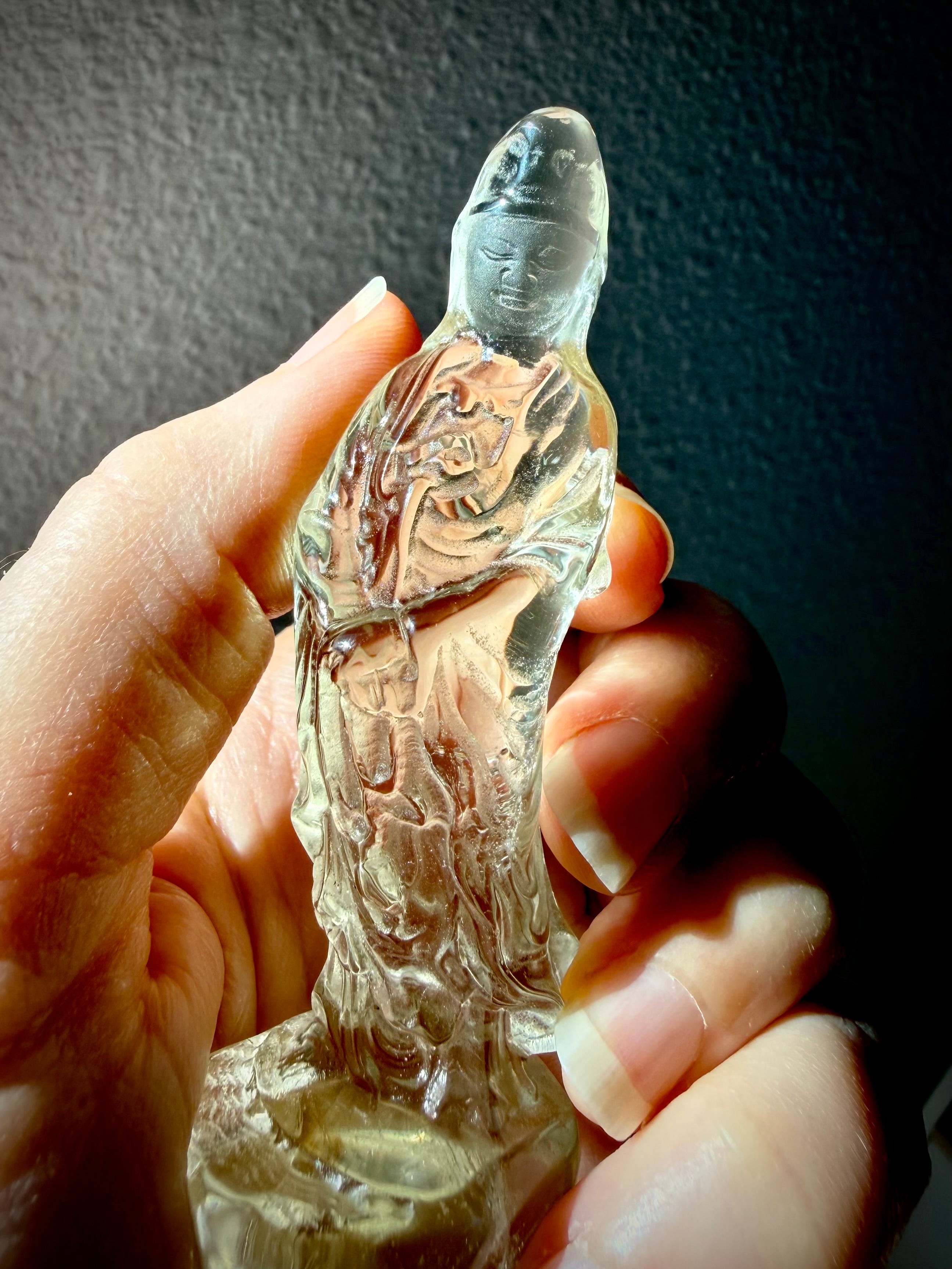handheld Citrine Quan Yin goddess carving with warm honey tones and polished translucent finish