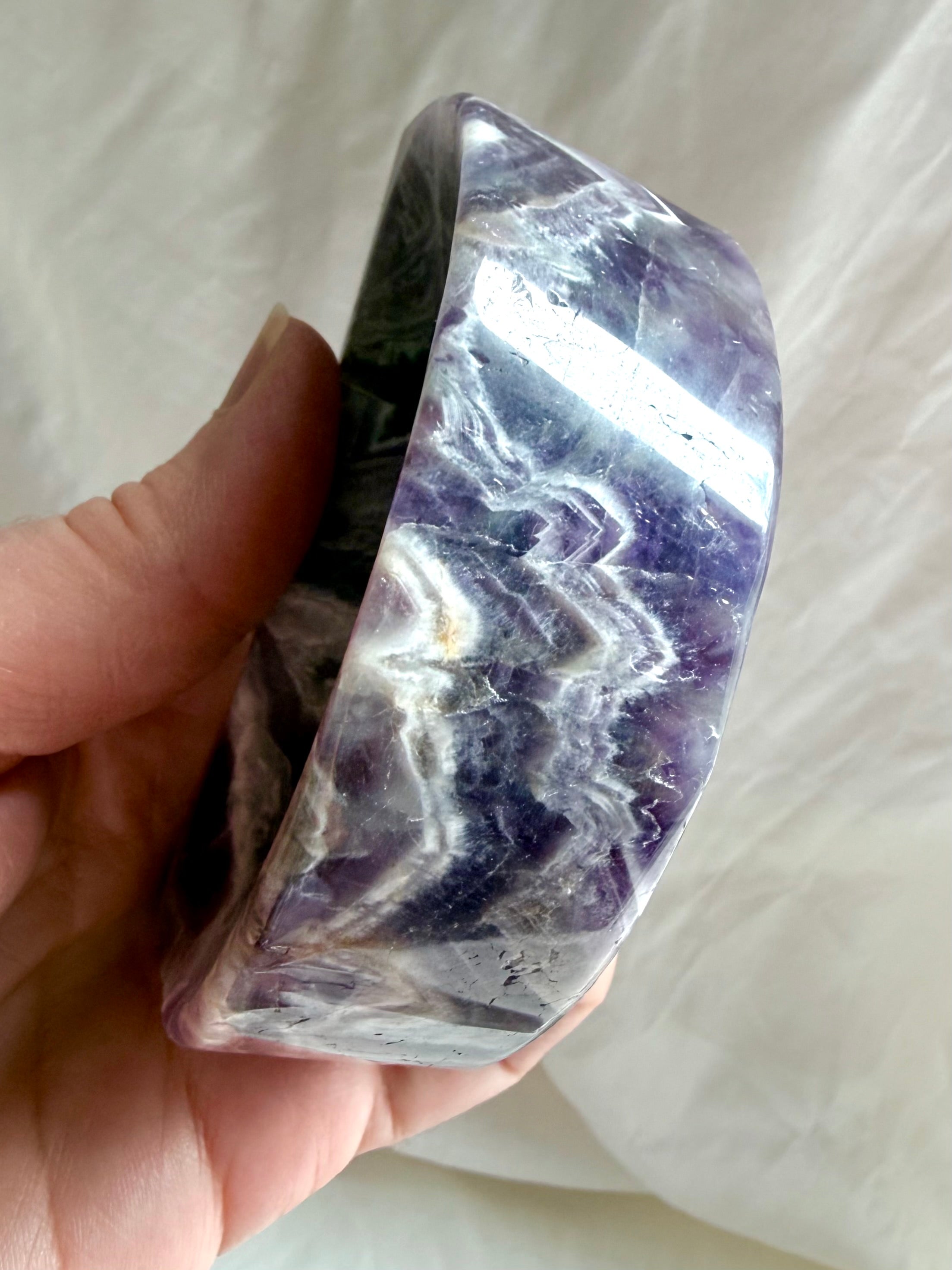 Side view of chevron Amethyst moon bowl highlighting thickness and banded crystal structure