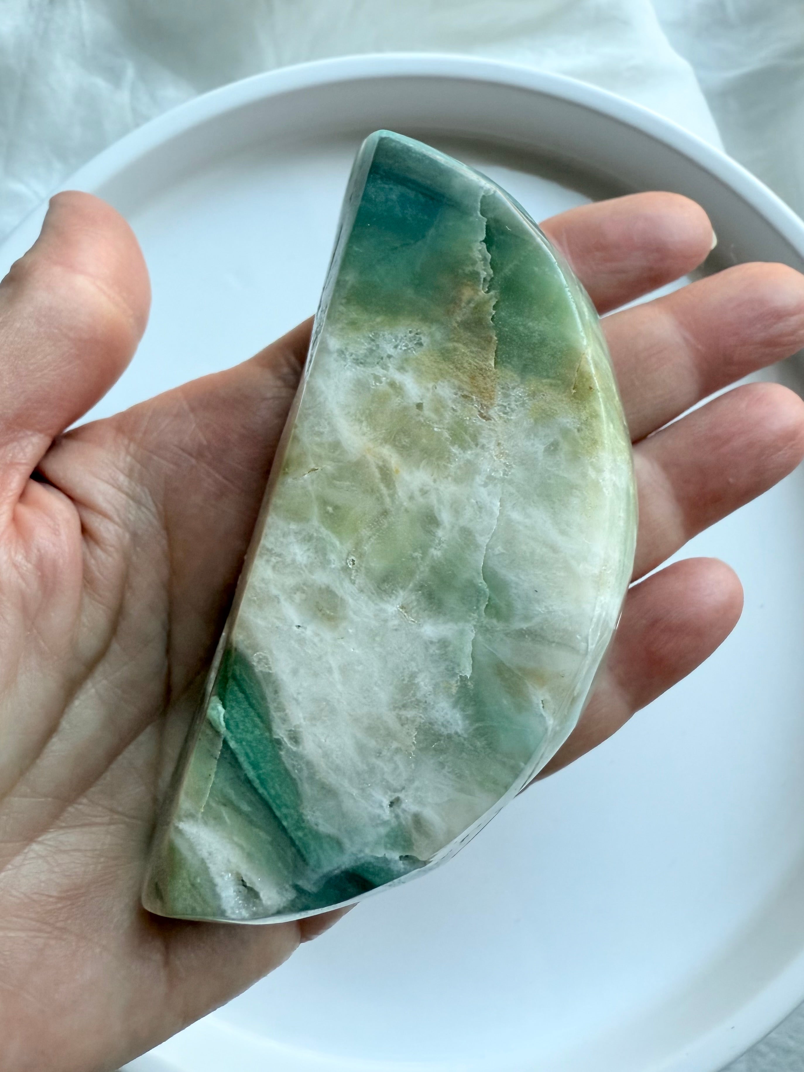 Sky Blue Quartz crescent moon bowl bottom view on palm