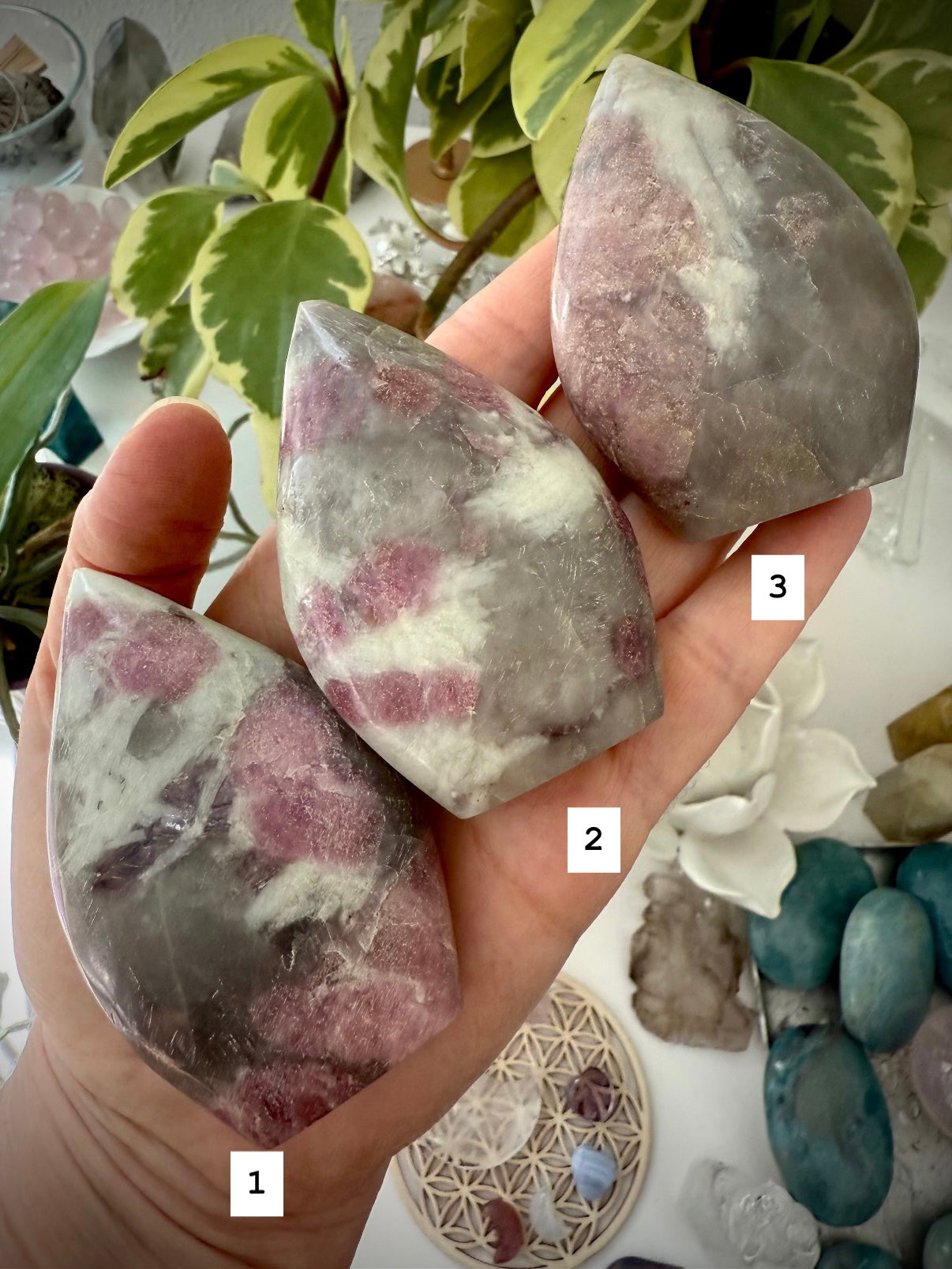 Crystal Flames made of Unicorn Stone — gemstone carvings with pink, purple, and earthy mineral patterns