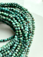 High-quality turquoise bead strands with rich matrix patterns and earthy green-blue tones
