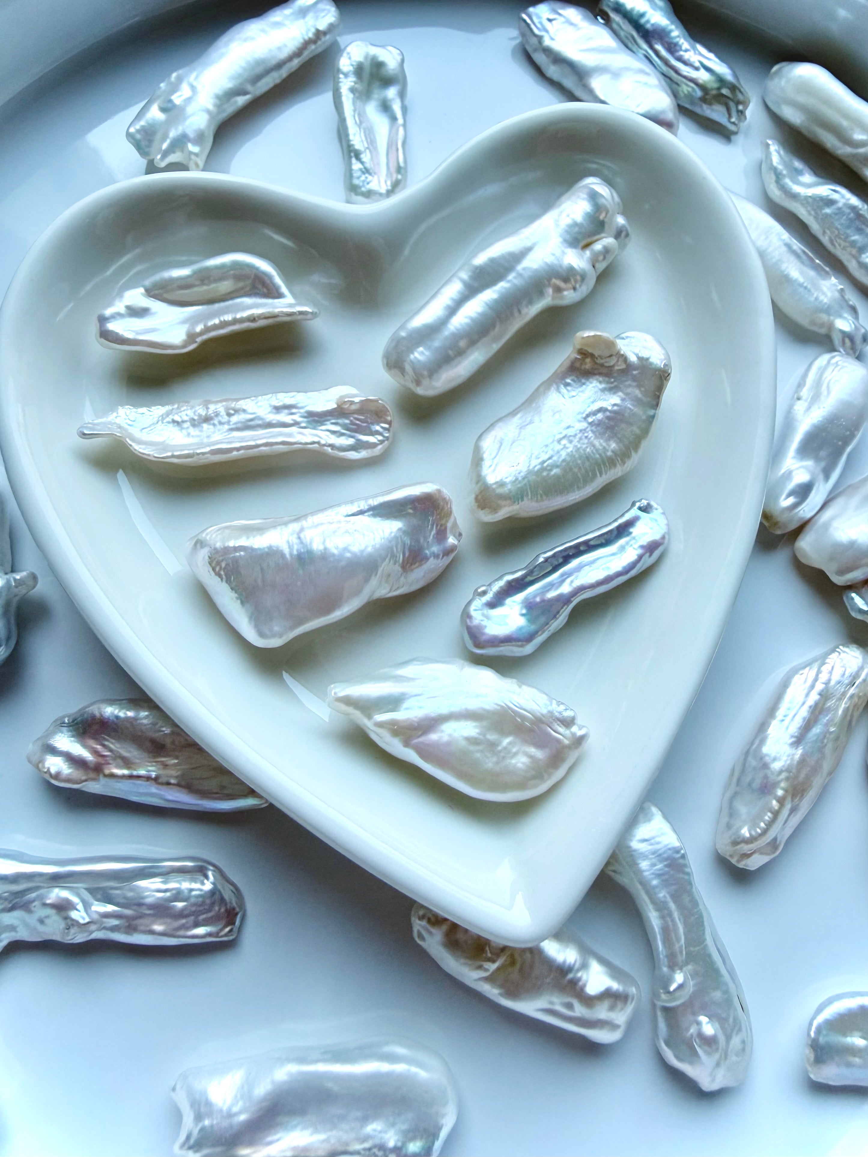 Baroque freshwater stick pearls displayed in heart dish showing luminous nacre and unique natural shapes