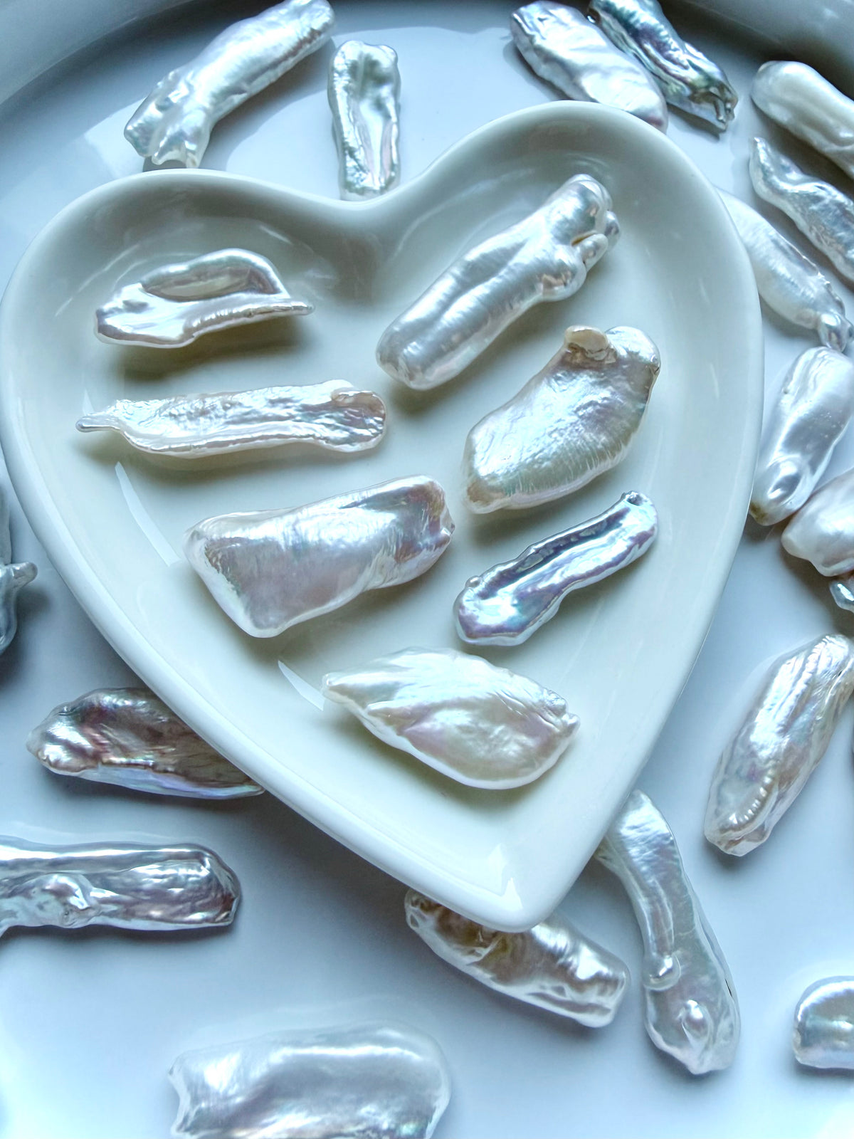 Baroque freshwater stick pearls displayed in heart dish showing luminous nacre and unique natural shapes
