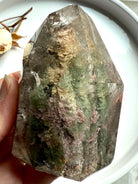 Polished Thousand Layer Garden Quartz tower with internal phantom layers and earthy green inclusions